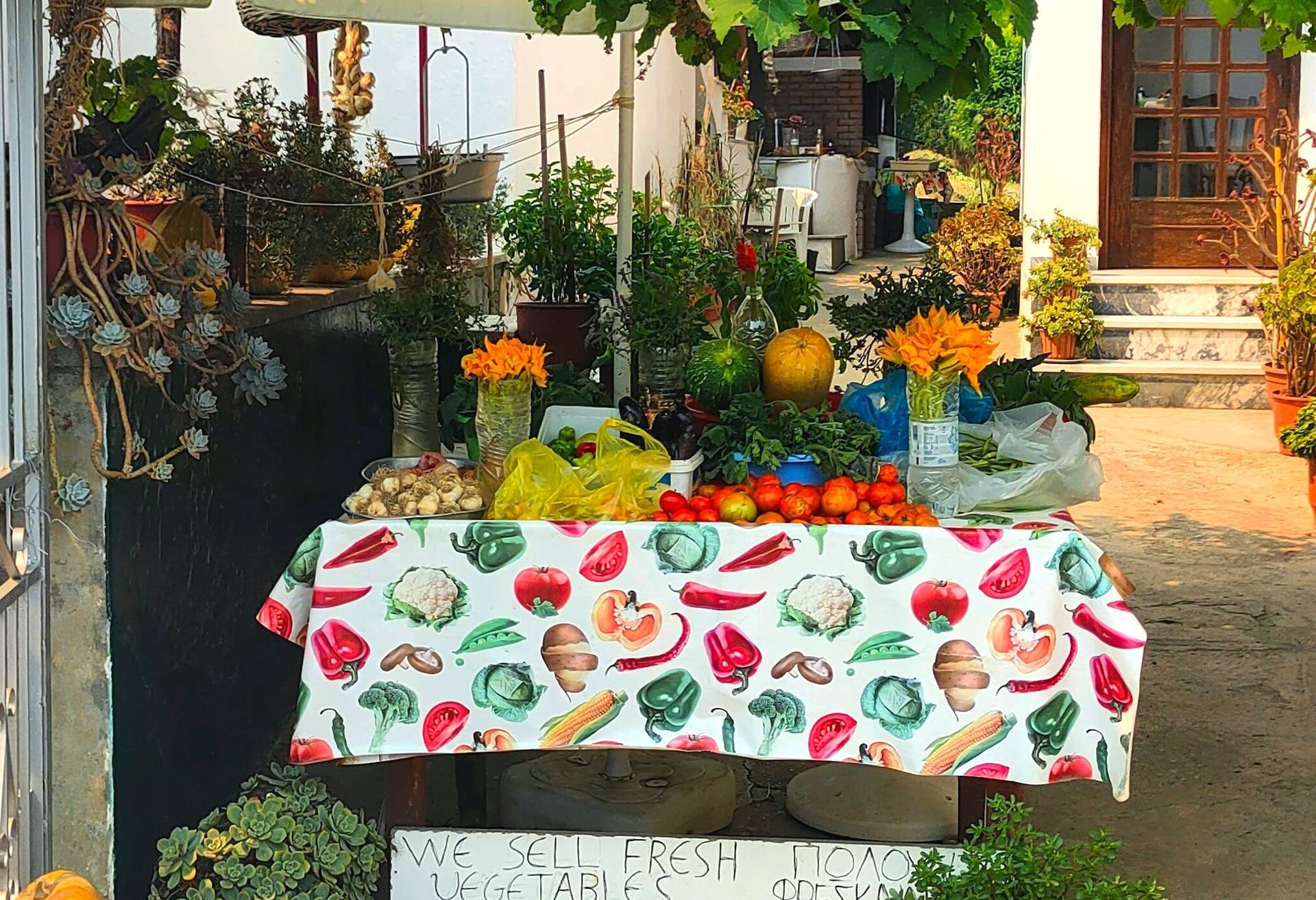 A table with a tablecloth with vegetables on it in Skopelos, Greece.