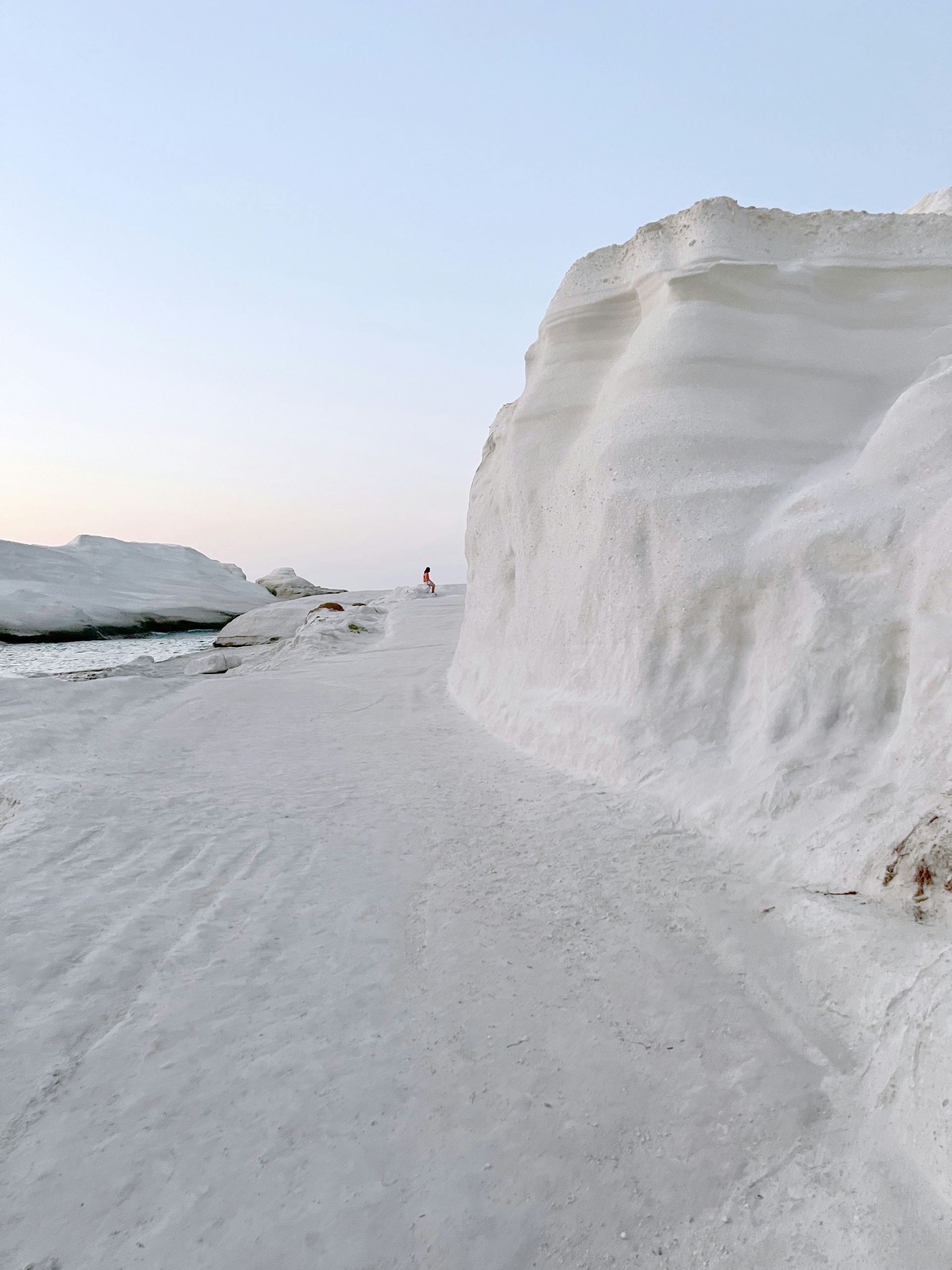 There is a large pile of snow on the side of the road in Milos, Greece.