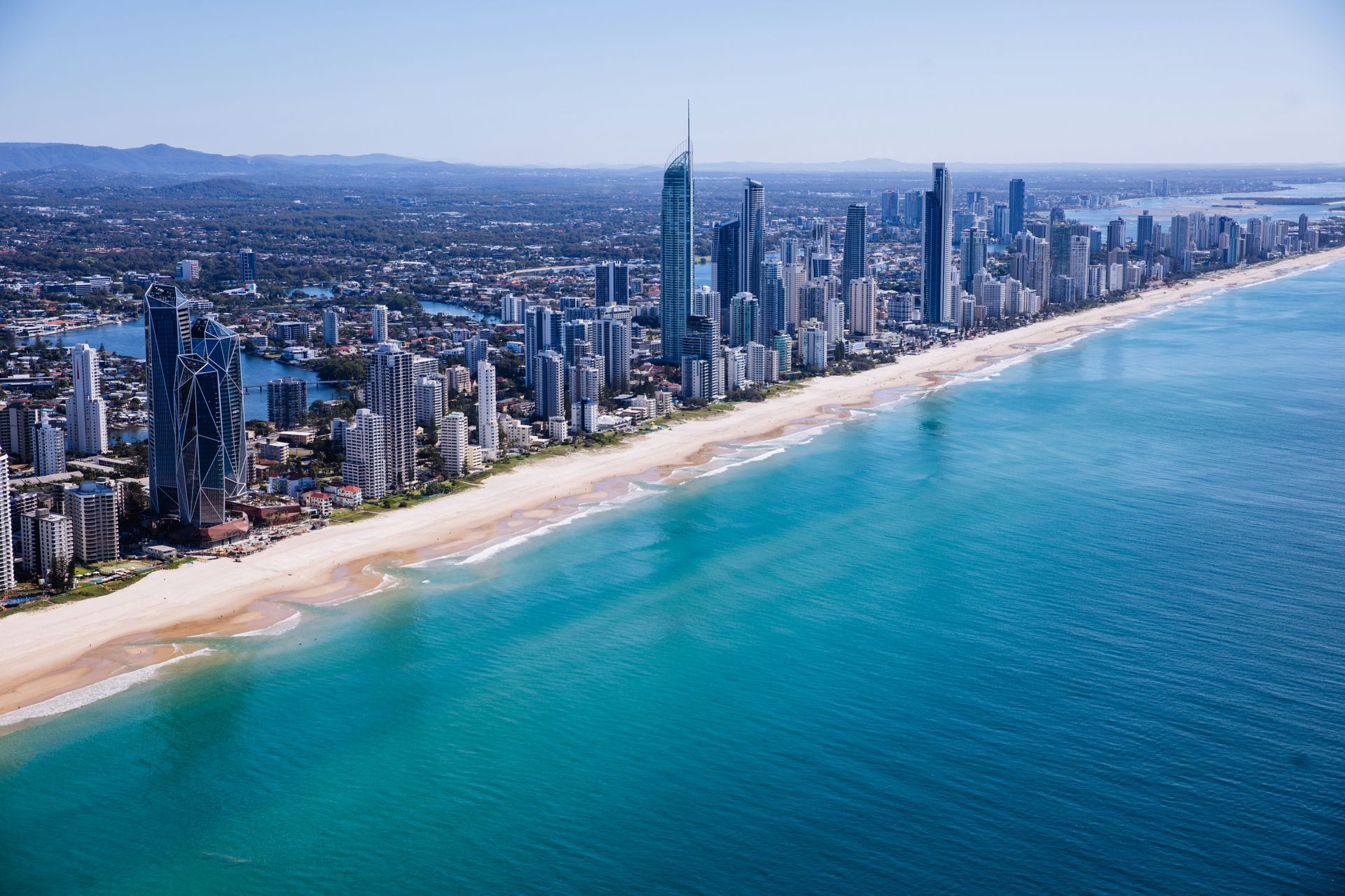 An aerial view of Gold Coast city behind Surfers Paradise Beach in Australia.