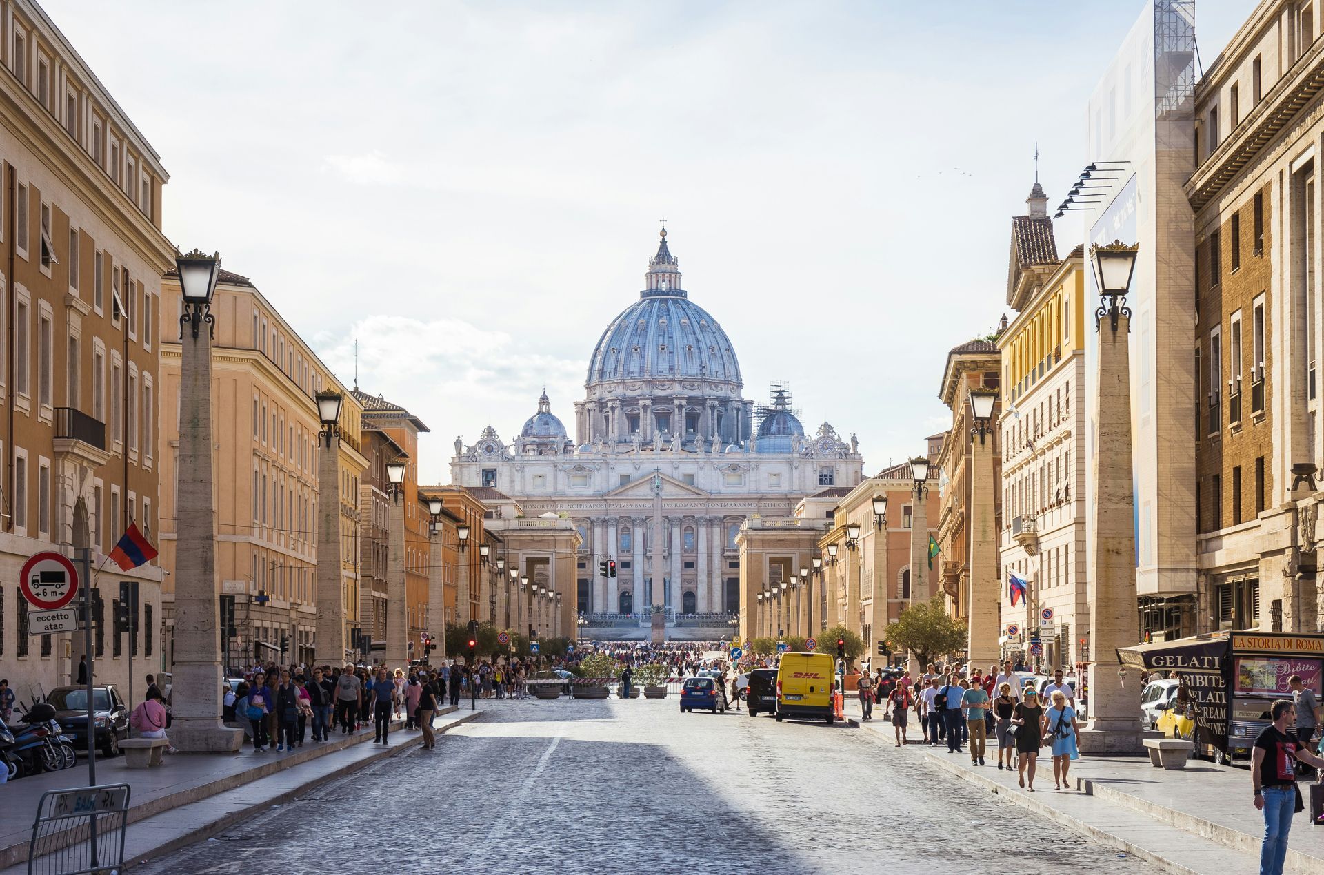 A city street with St. Peter's Basilica in the background in Rome.
