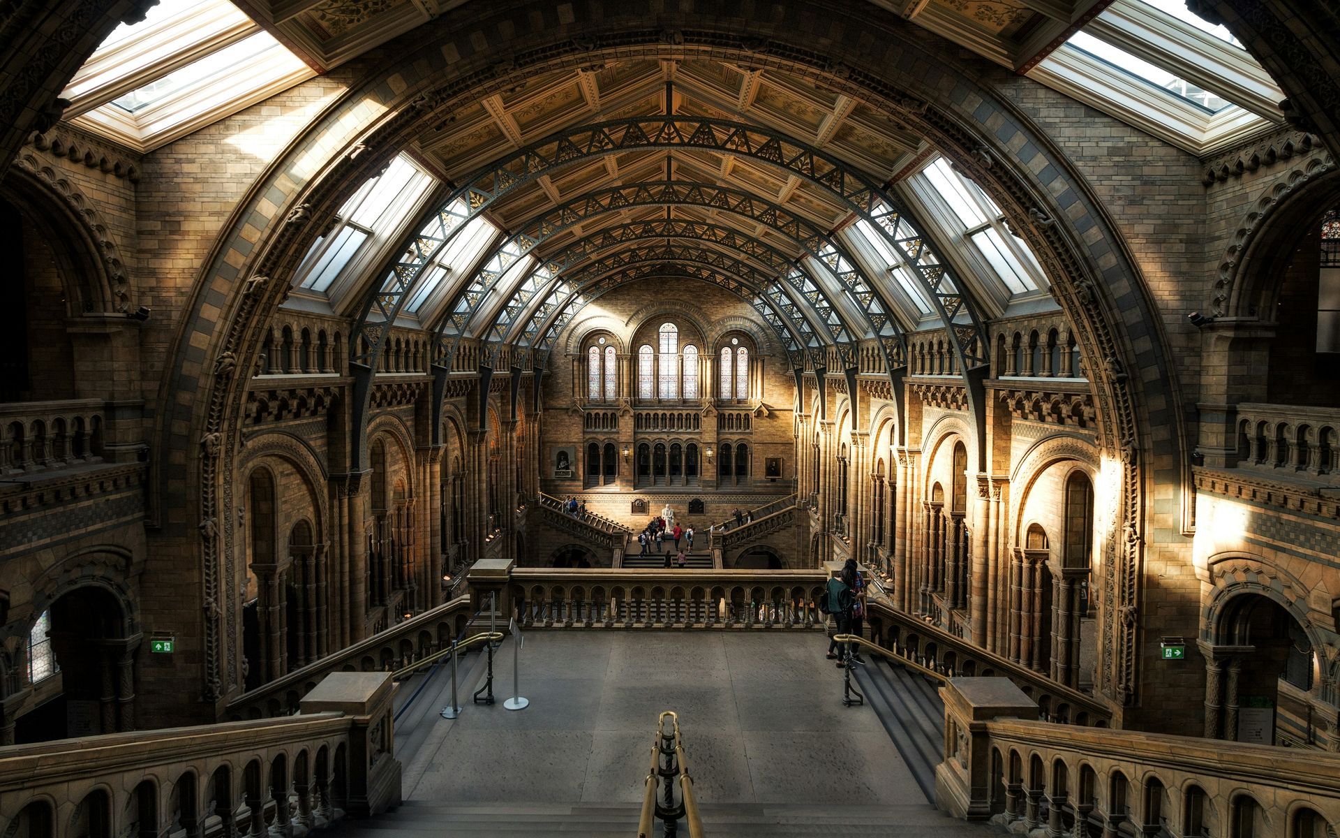 Ornate, arched hallway with natural light from skylights; Natural History Museum in London.