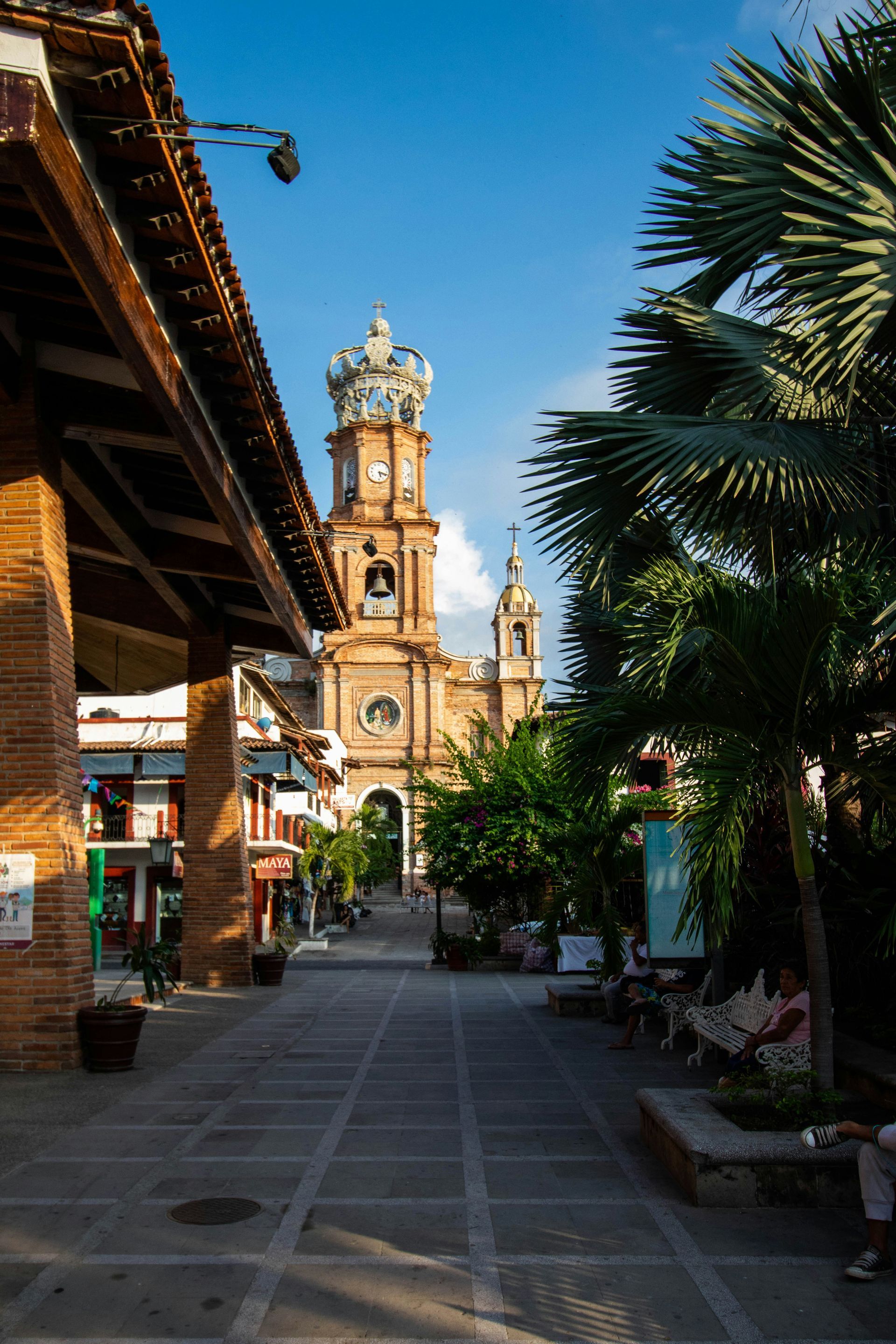 A view down a cobblestone street toward a cathedral in Puerto Vallarta, Mexico.