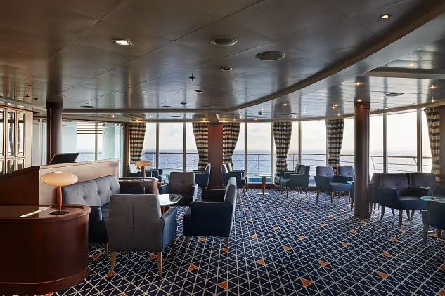 A large room with a lot of chairs and tables on Silversea's Silver Whisper cruise ship.