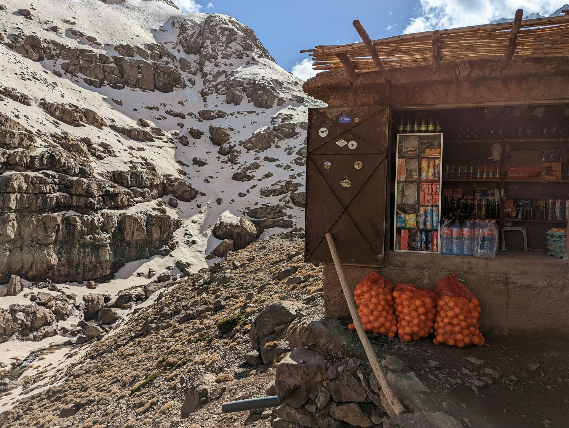 A small store with bags of potatoes in front of it in Toubkal, Morocco.