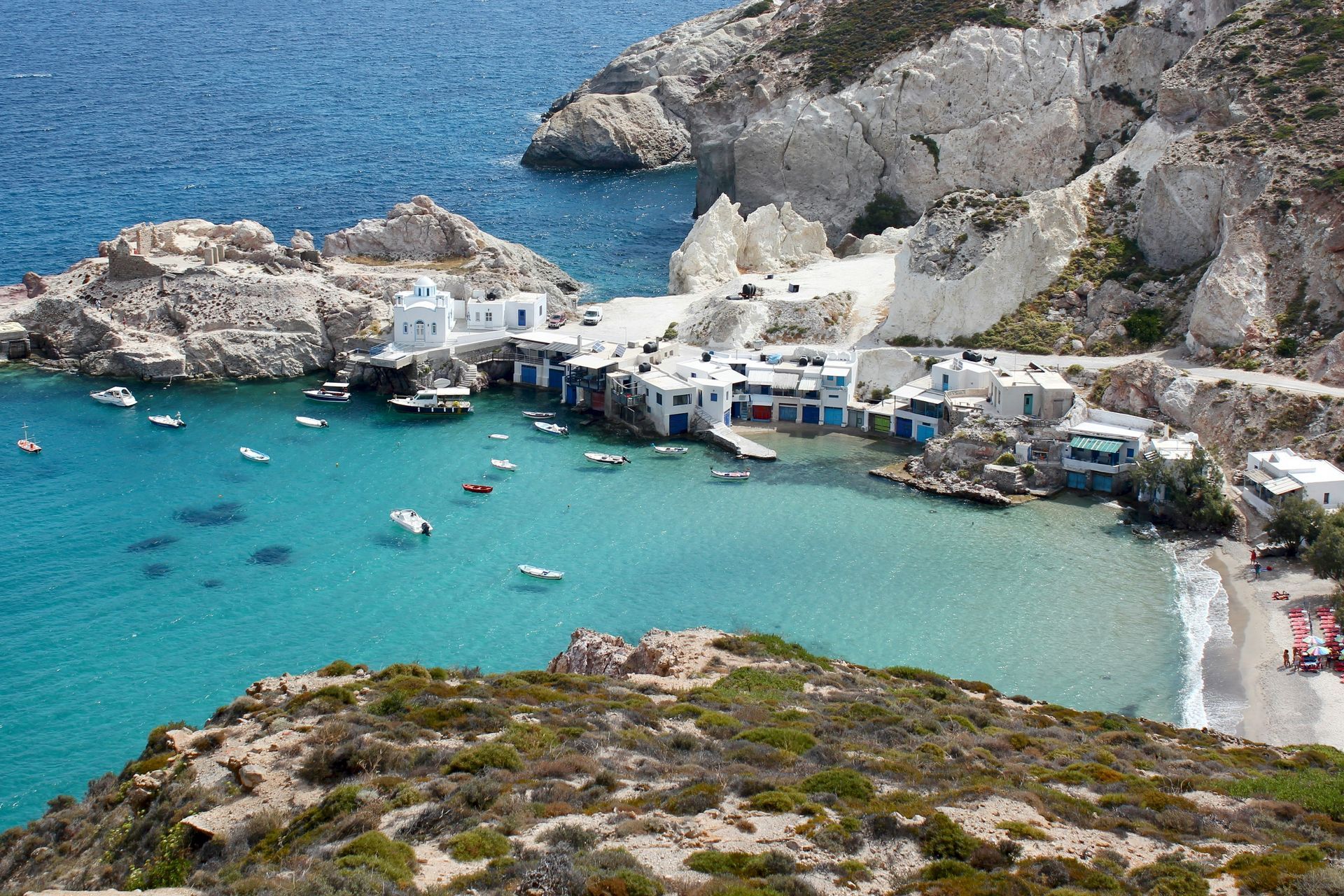 An aerial view of a small town in the middle of the ocean in Milos, Greece.