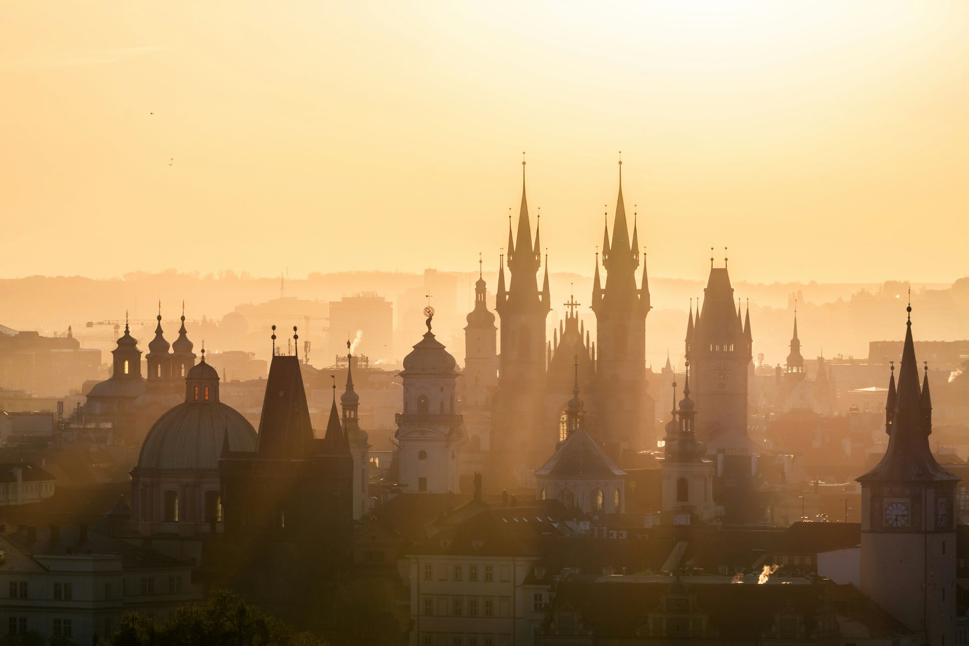 Prague's skyline with a lot of buildings and towers at sunset,