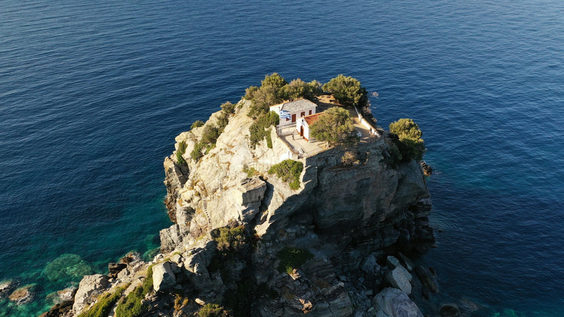 An aerial view of a small island in the middle of the ocean in Skopelos, Greece.