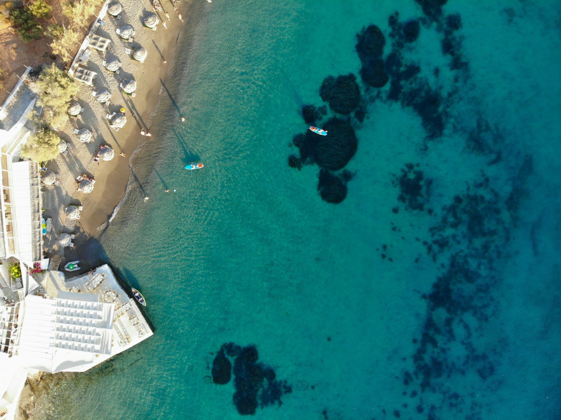 An aerial view of a beach and a body of water in Paros, Greece.
