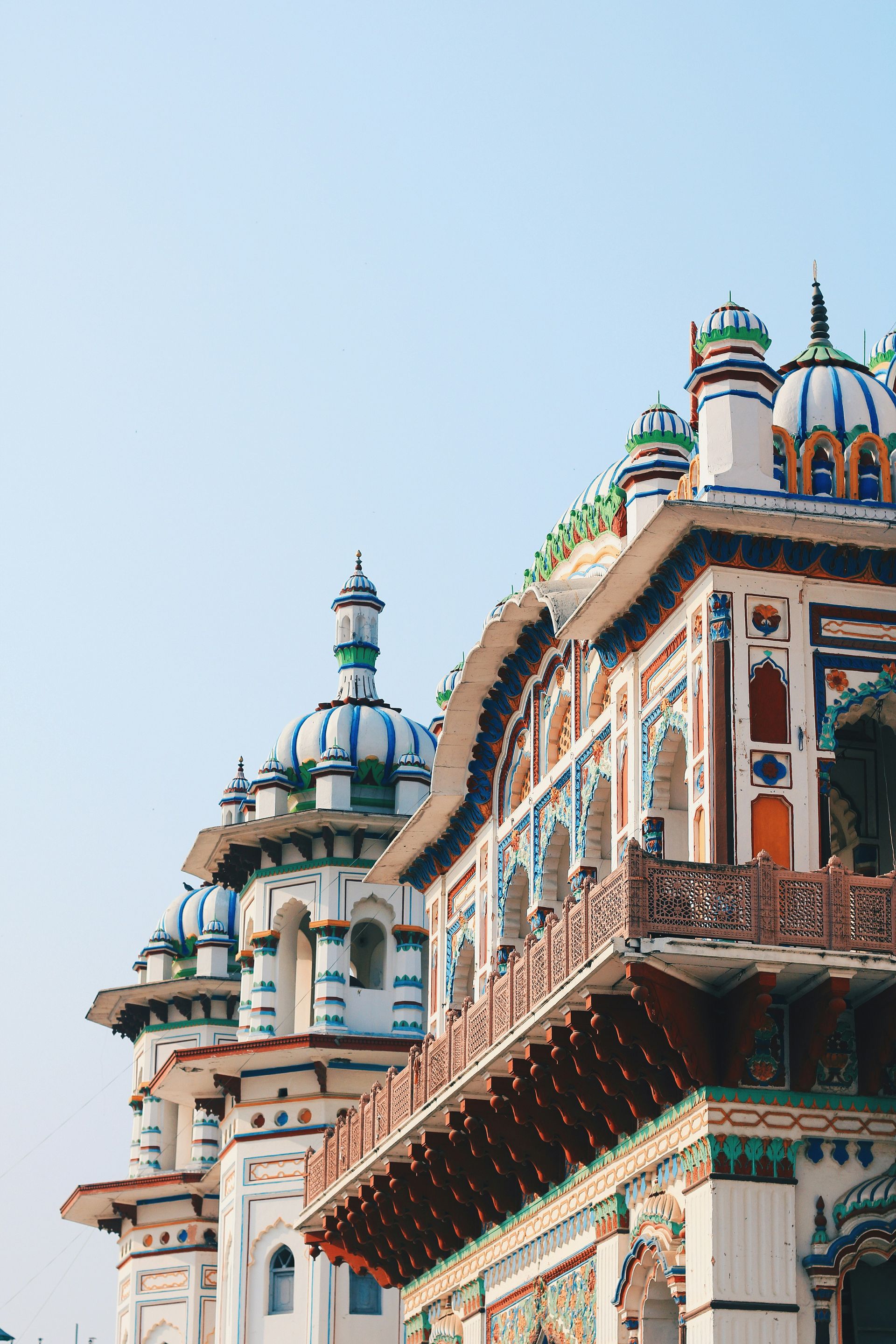 Ornate white, blue, and orange temple domes in Janakpur, Nepal.