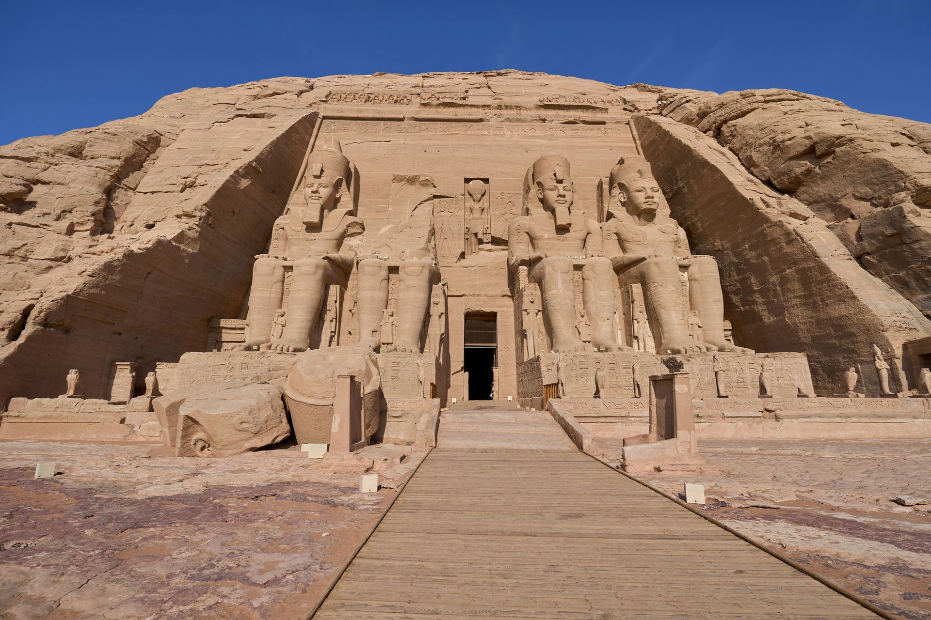 A large stone building is sitting on top of a hill in Abu Simbel, Egypt.