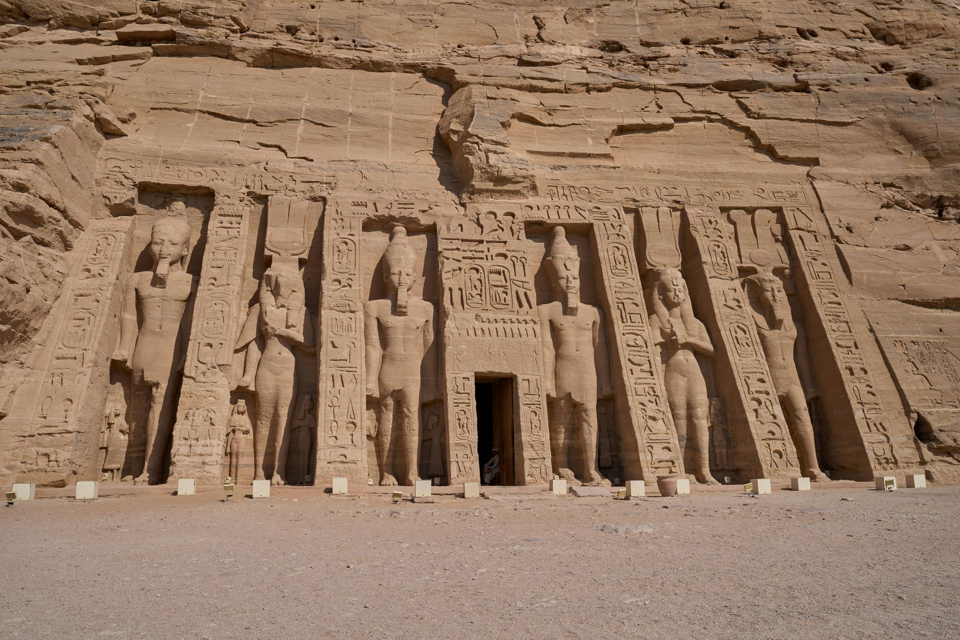 A very old building with a lot of statues on it in Abu Simbel, Egypt.