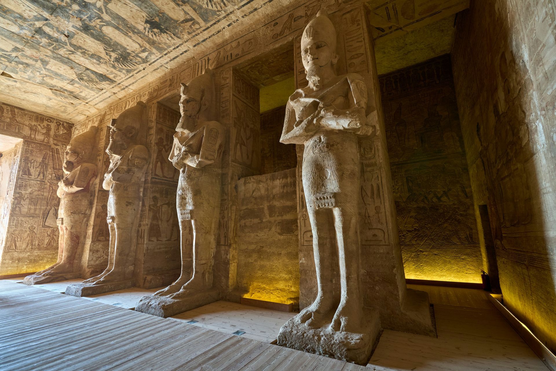 A group of statues standing next to each other in a room in Abu Simbel, Egypt.