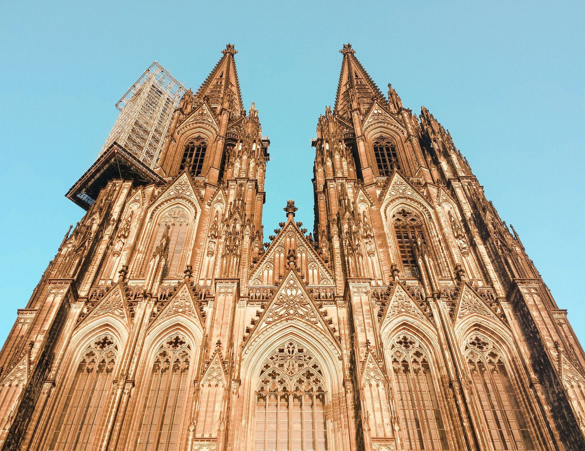 Gothic cathedral with two spires against a clear blue sky; Cologne, Germany.
