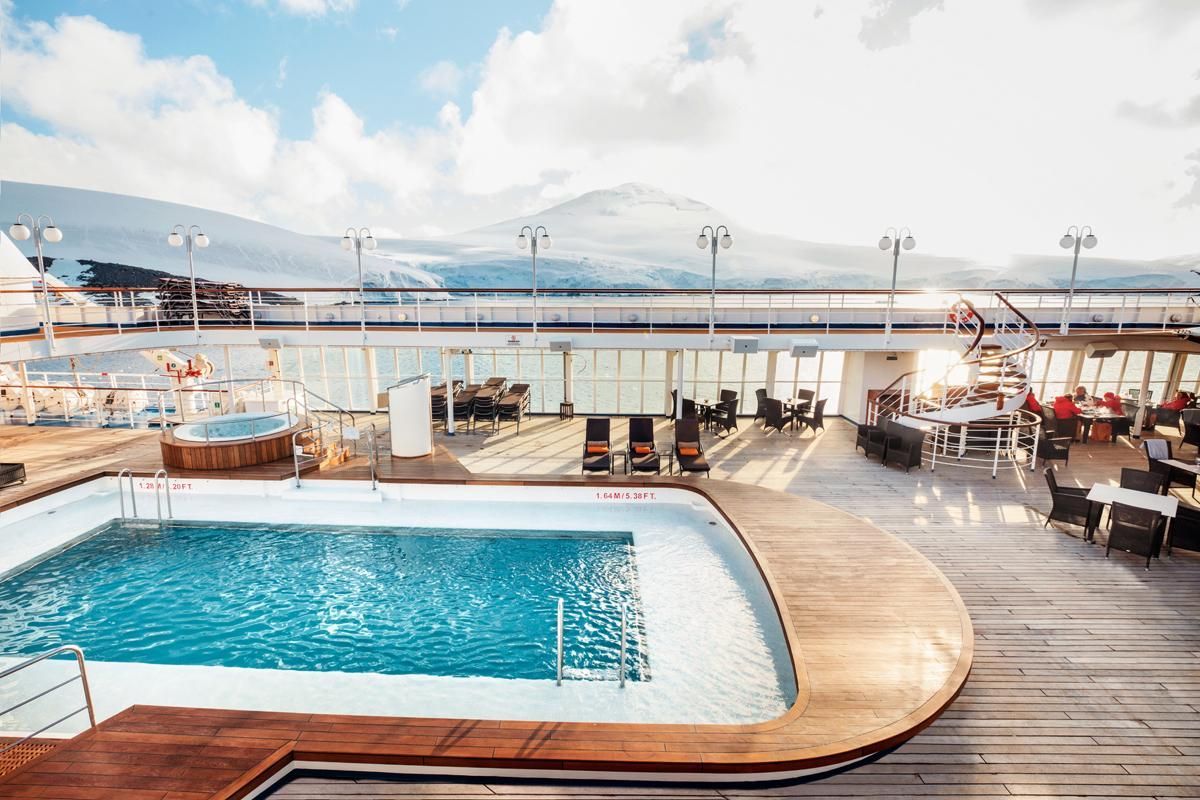 A large swimming pool on the deck of Silversea's Silver Cloud Expedition Cruise Ship.