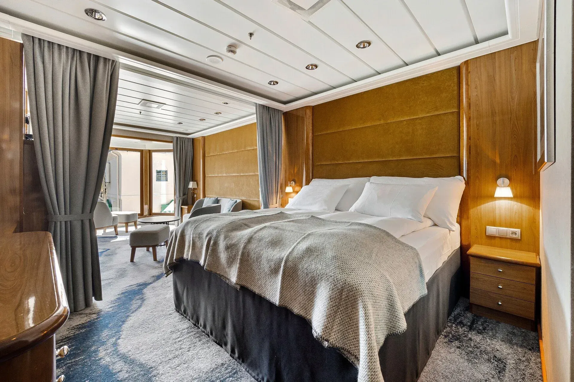 There is a large bed in the middle of the room on Hurtigruten's MS Trollfjord cruise ship.