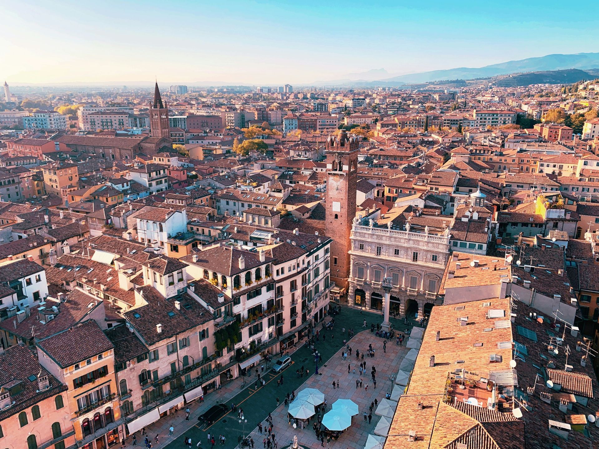An aerial view of Verona, Italy with a clock tower in the middle of it.