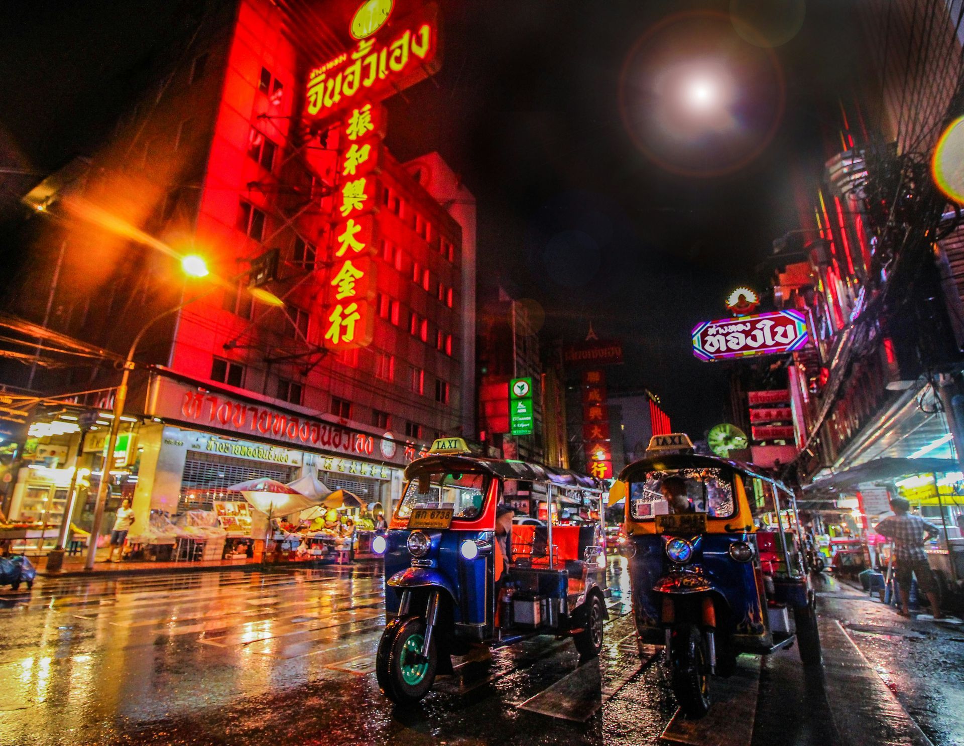 A busy street at night with neon lights in Bangkok, Thailand.