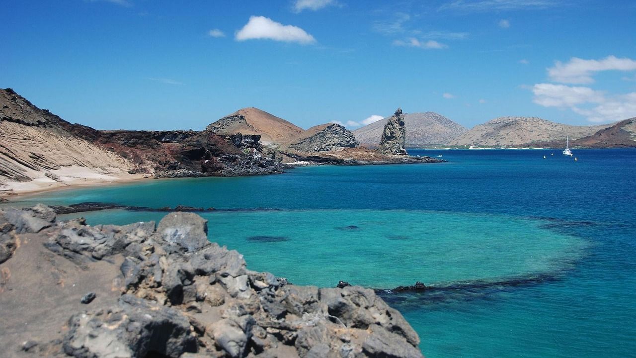 A large body of water with mountains in the background in the Galapagos.