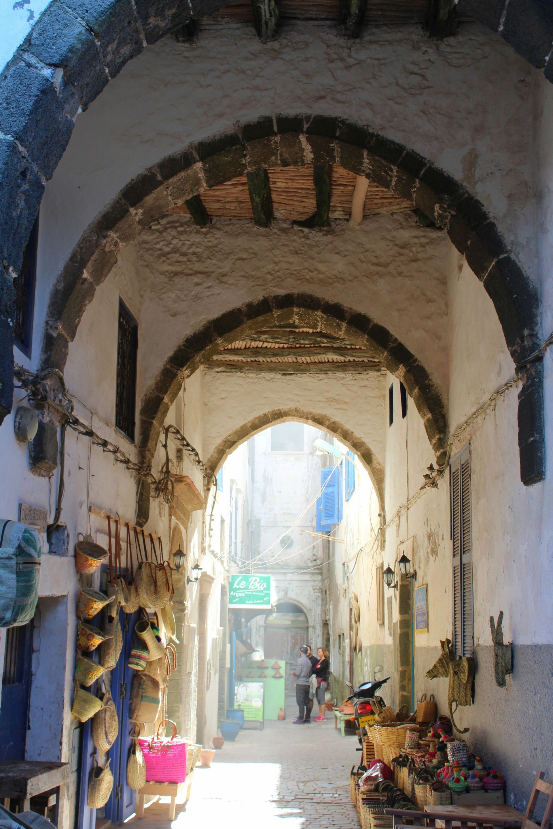 A narrow alleyway with a sign in Essaouira, Morocco.