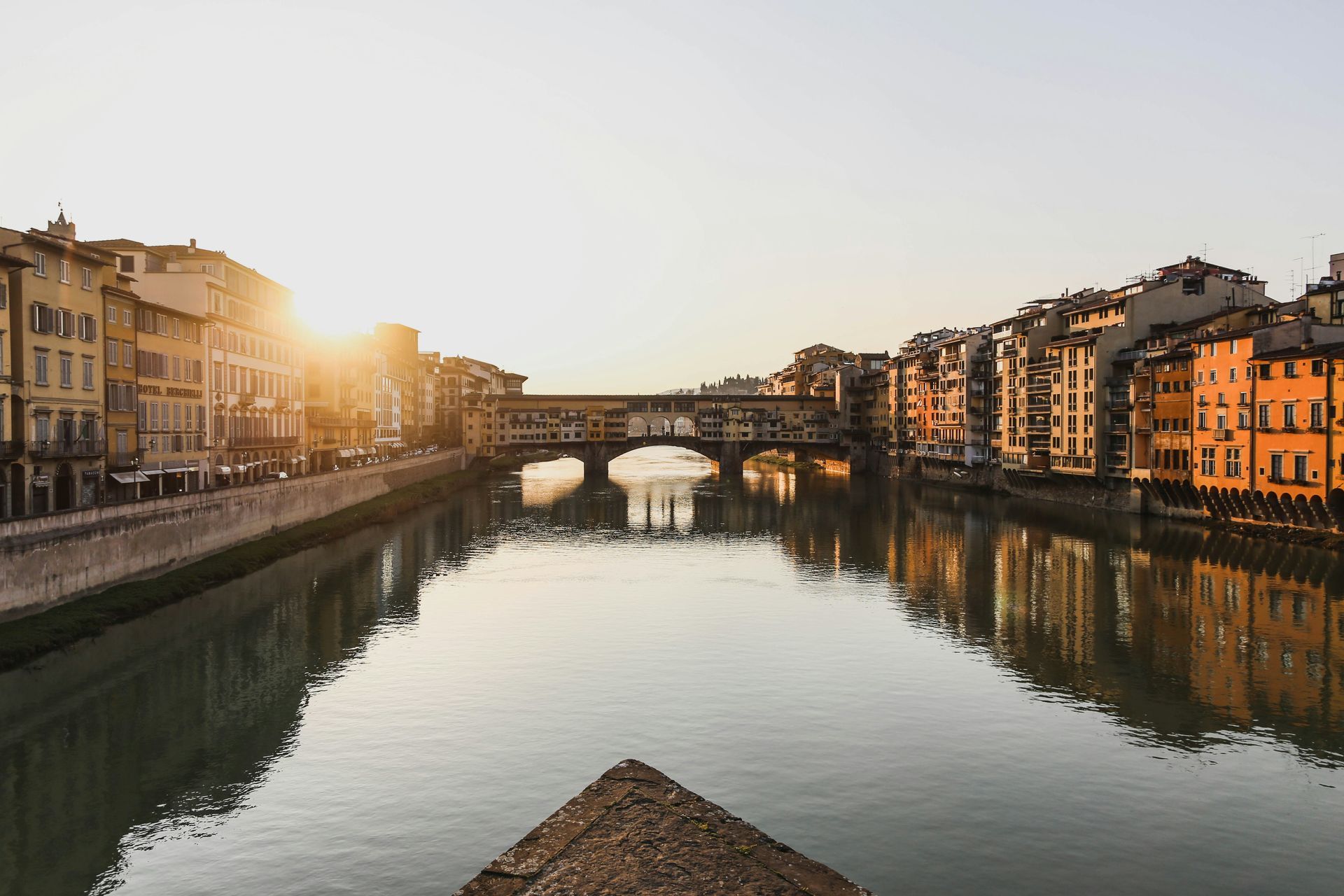 There is a bridge over a river in the middle of Florence.