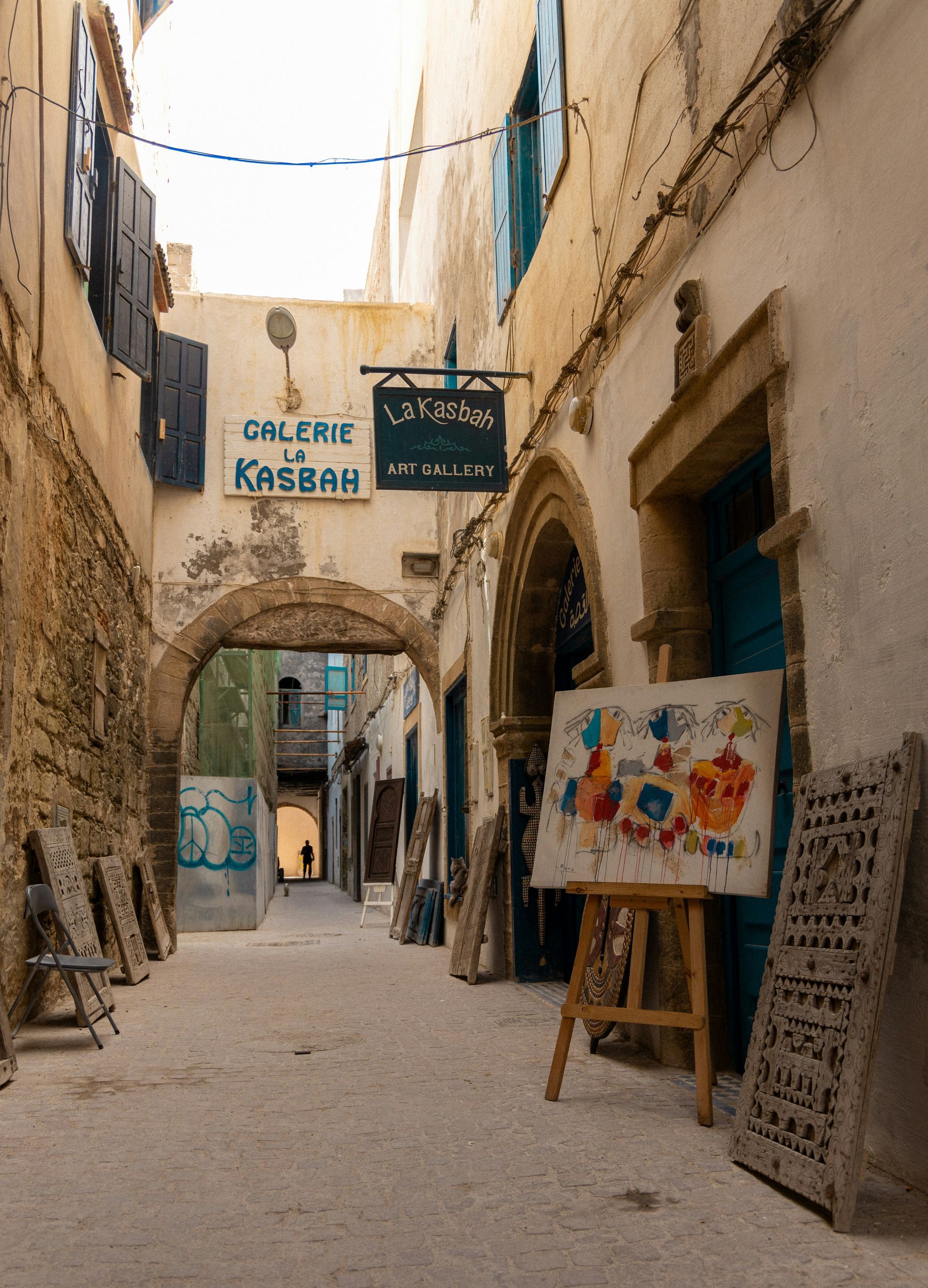 A narrow alleyway with a sign that says galerie kasbah in Essaouira, Morocco.
