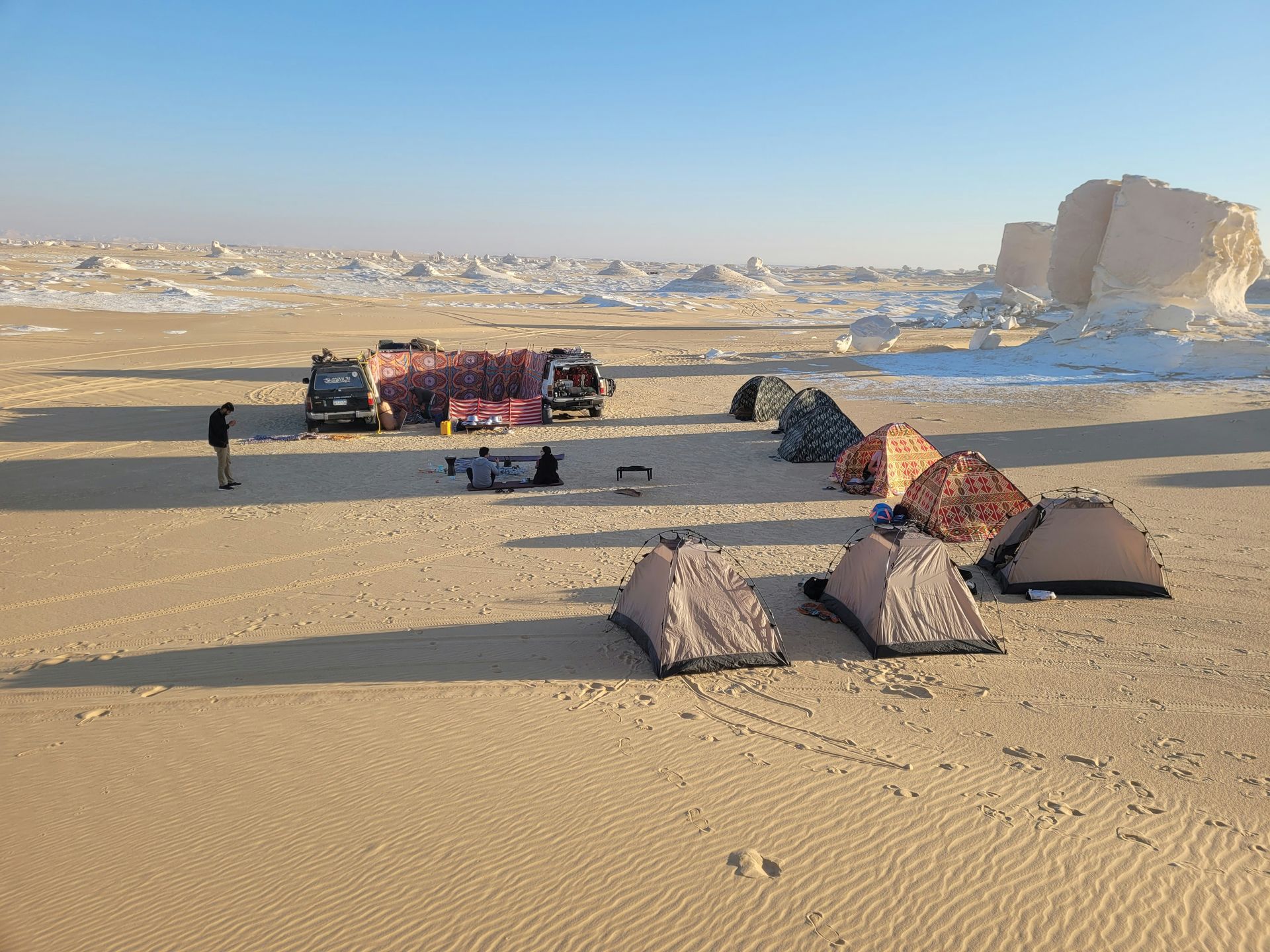 A group of tents are sitting in the middle of White Desert National Park in Egypt.