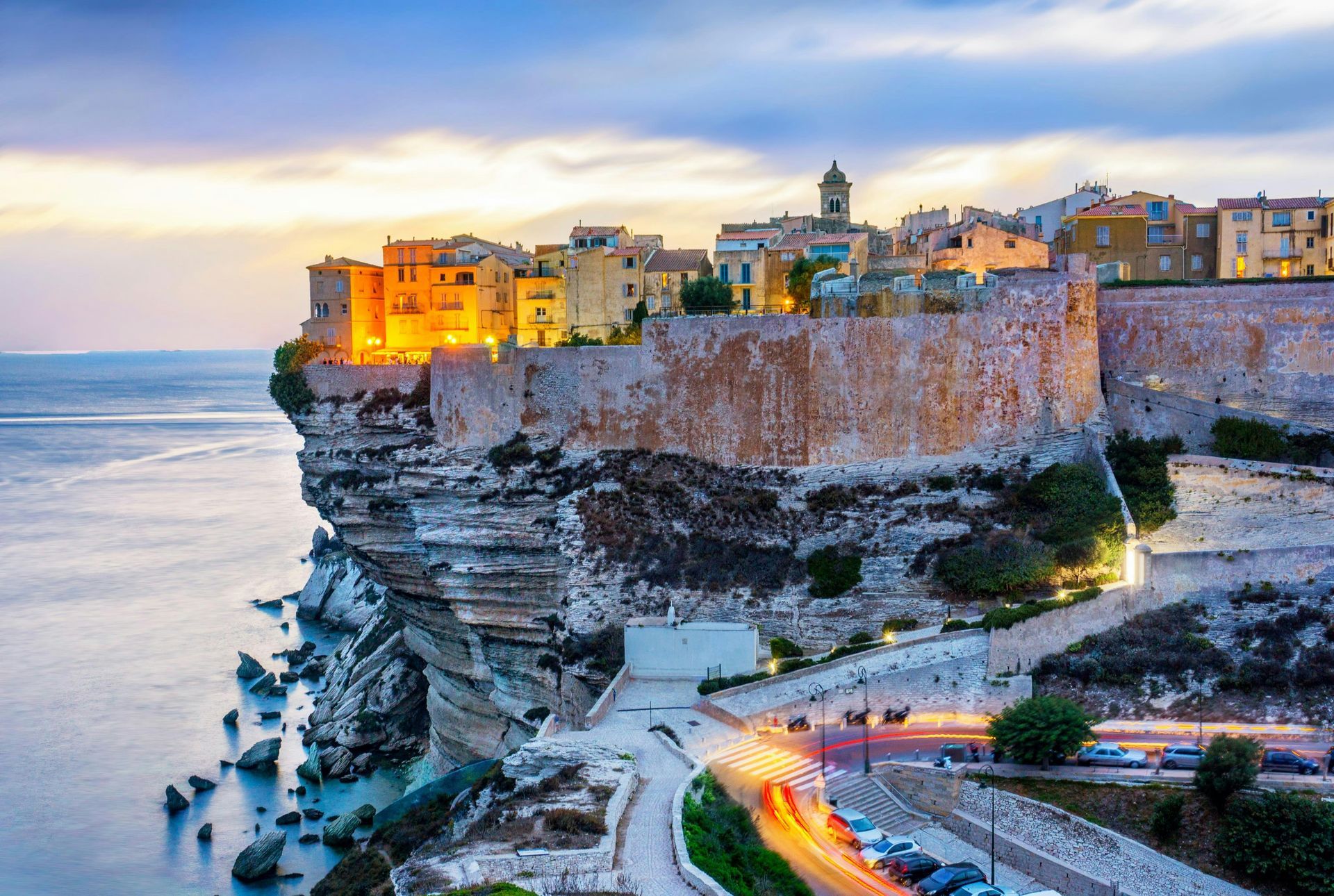 The city of Bonifacio is sitting on top of a cliff overlooking the ocean in Corsica, France.