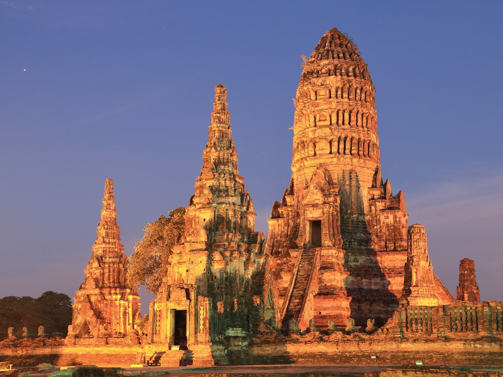 A large temple with a blue sky in the background in Ayutthaya, Thailand.