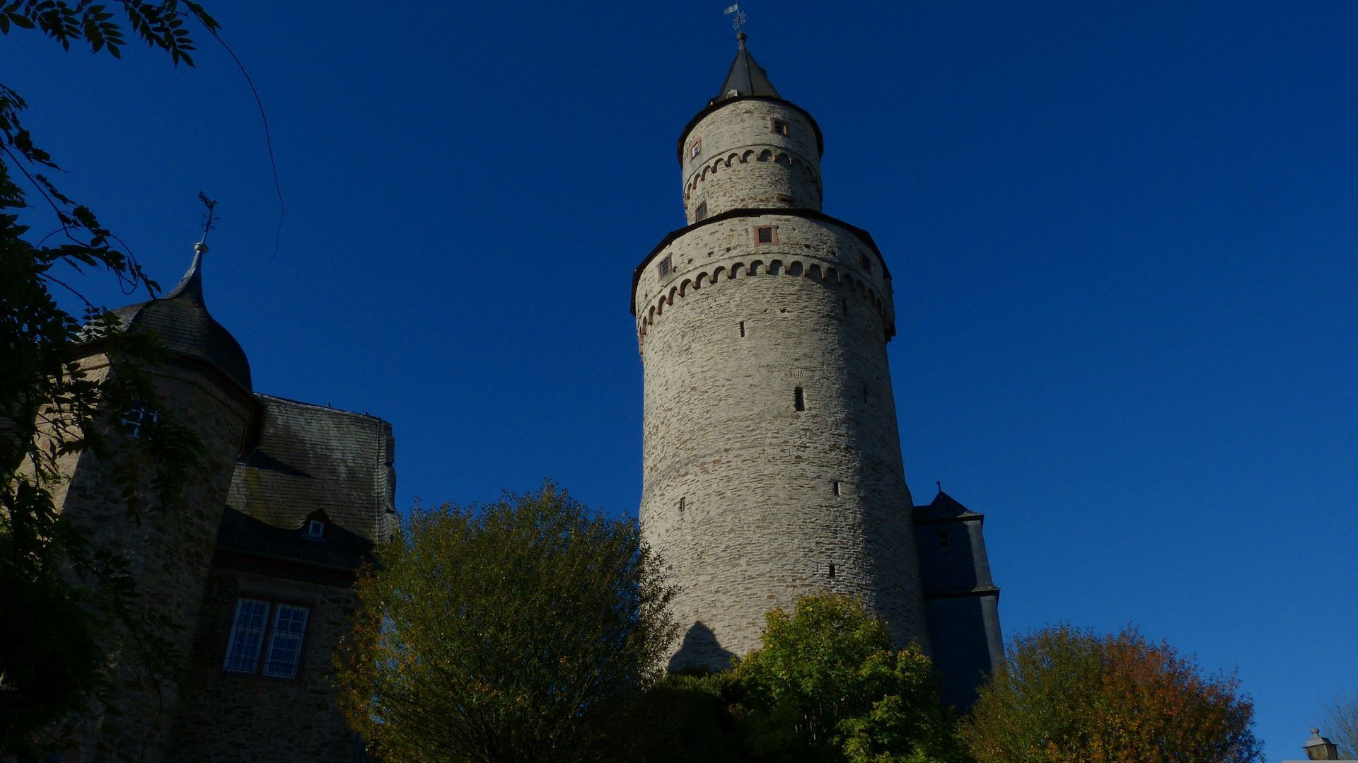 A large castle tower with a blue sky in the background in Idstein, Germany.