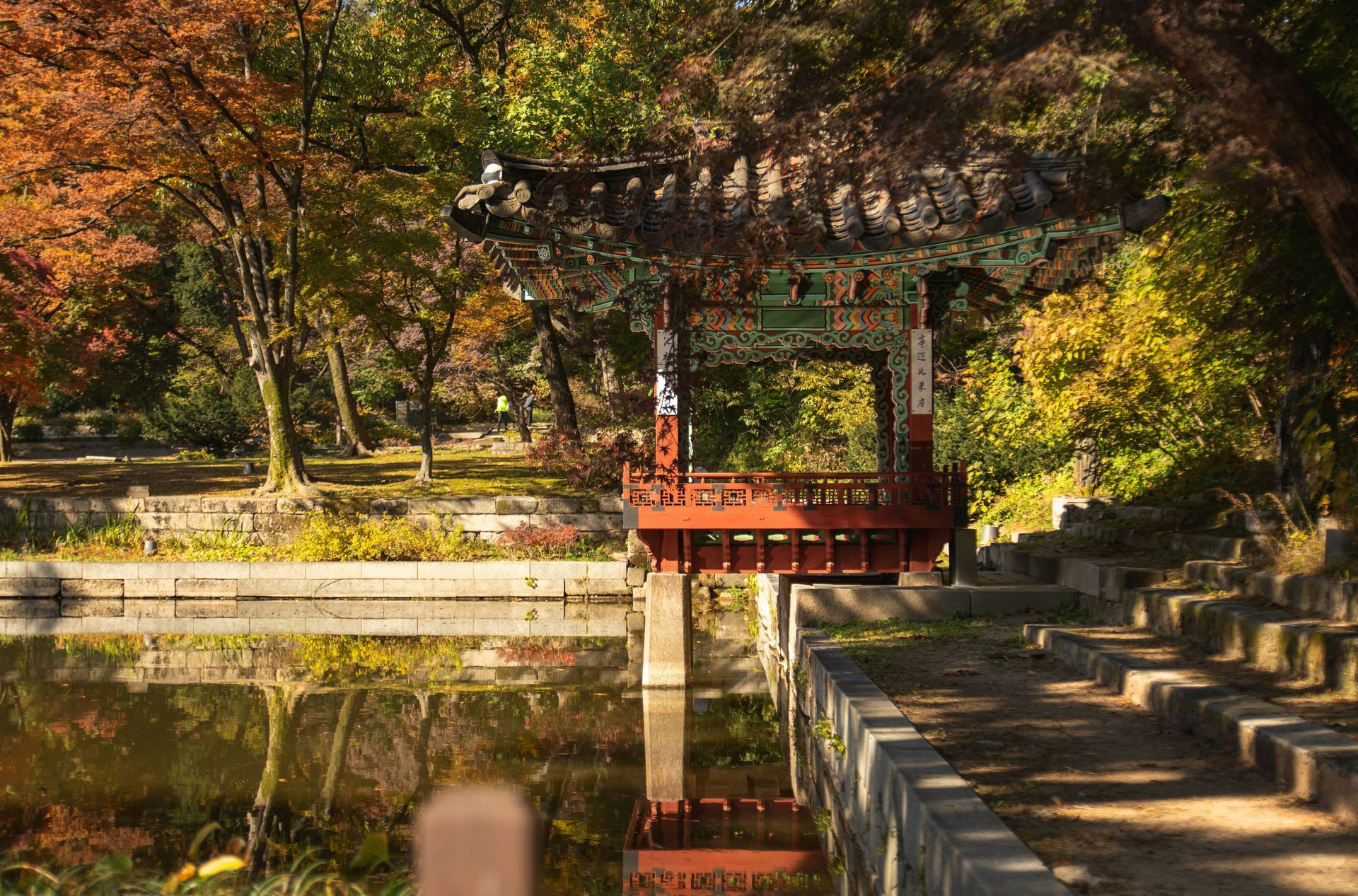 A traditional Korean pavilion reflected in calm water at Changdeokgung Palace, South Korea.