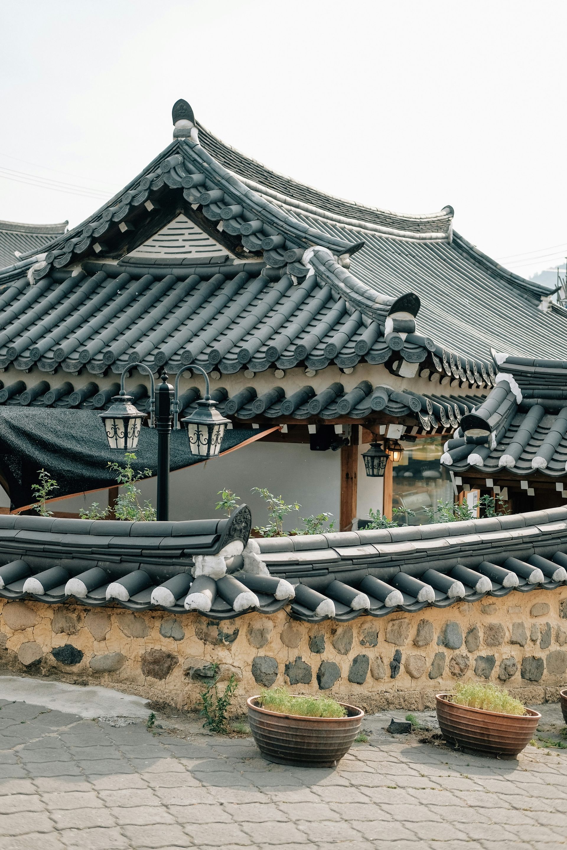 Korean traditional tiled-roof house and stone wall, with brick walkway in Gyeongju, South Korea.