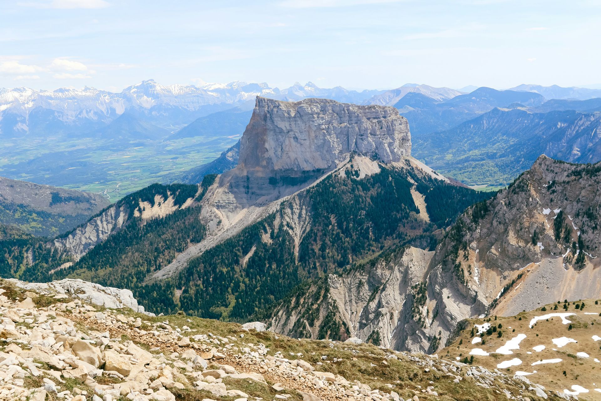 A view of a mountain range from the top of a mountain in Grenoble, France.