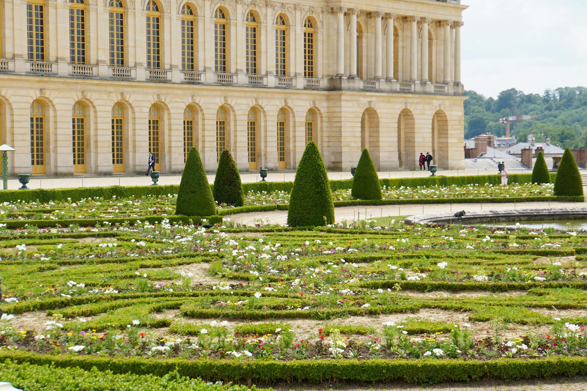 A large building with a garden in front of it at the Palace of Versailles in France.