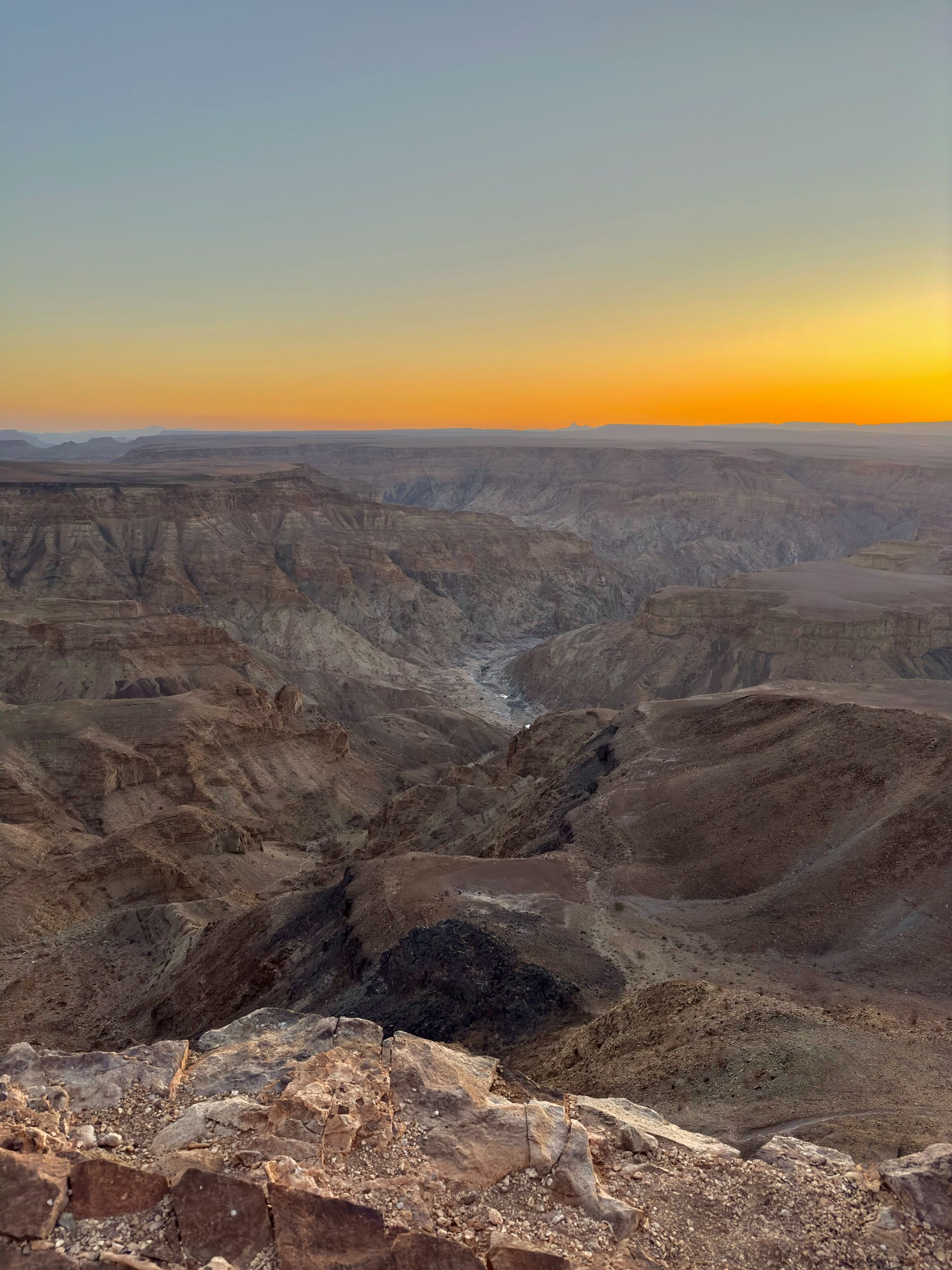 Sunrise over Fish River Canyon, Namibia. Brown canyons, golden sky.
