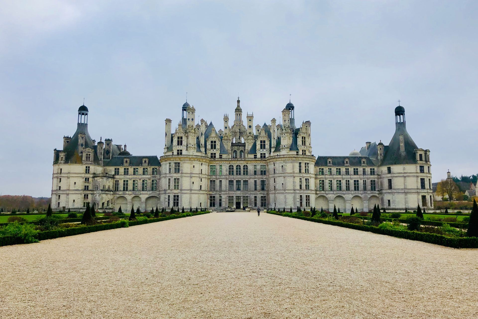 The Château de Chambord with a gravel driveway in front of it in France.