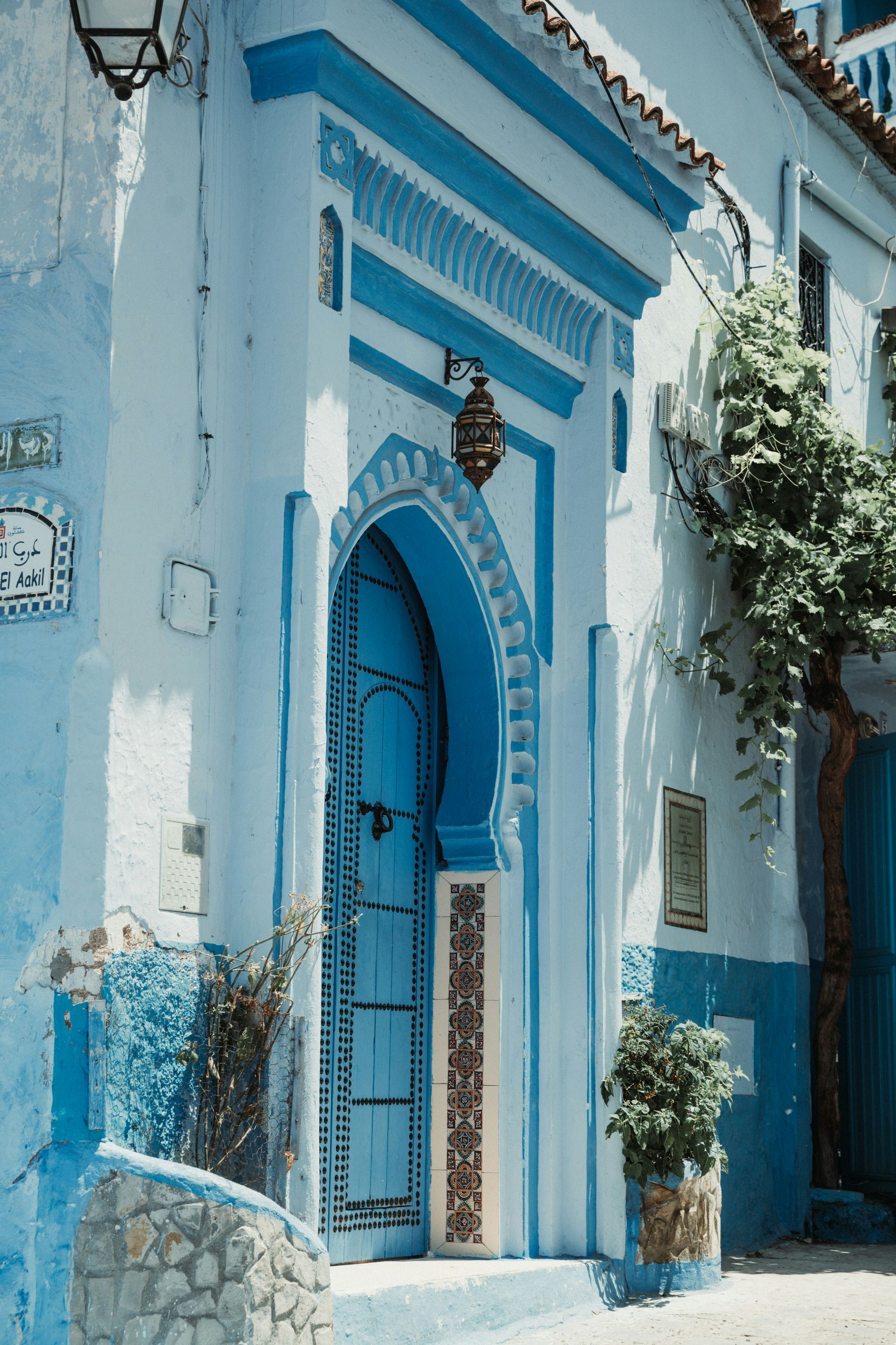 A blue and white building with a blue door in Chefchaouen, Morocco.