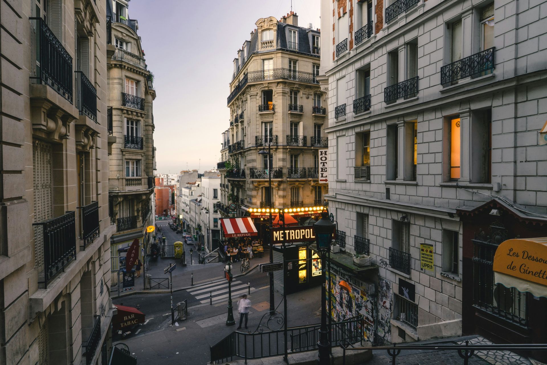 An aerial view of a city street of Montmartre with a metro sign in the middle of it in Paris, France.