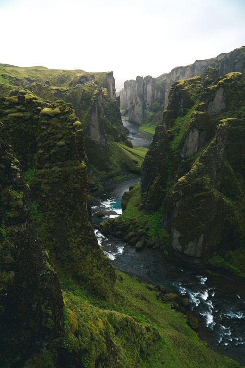 A river runs through a canyon between two mountains.