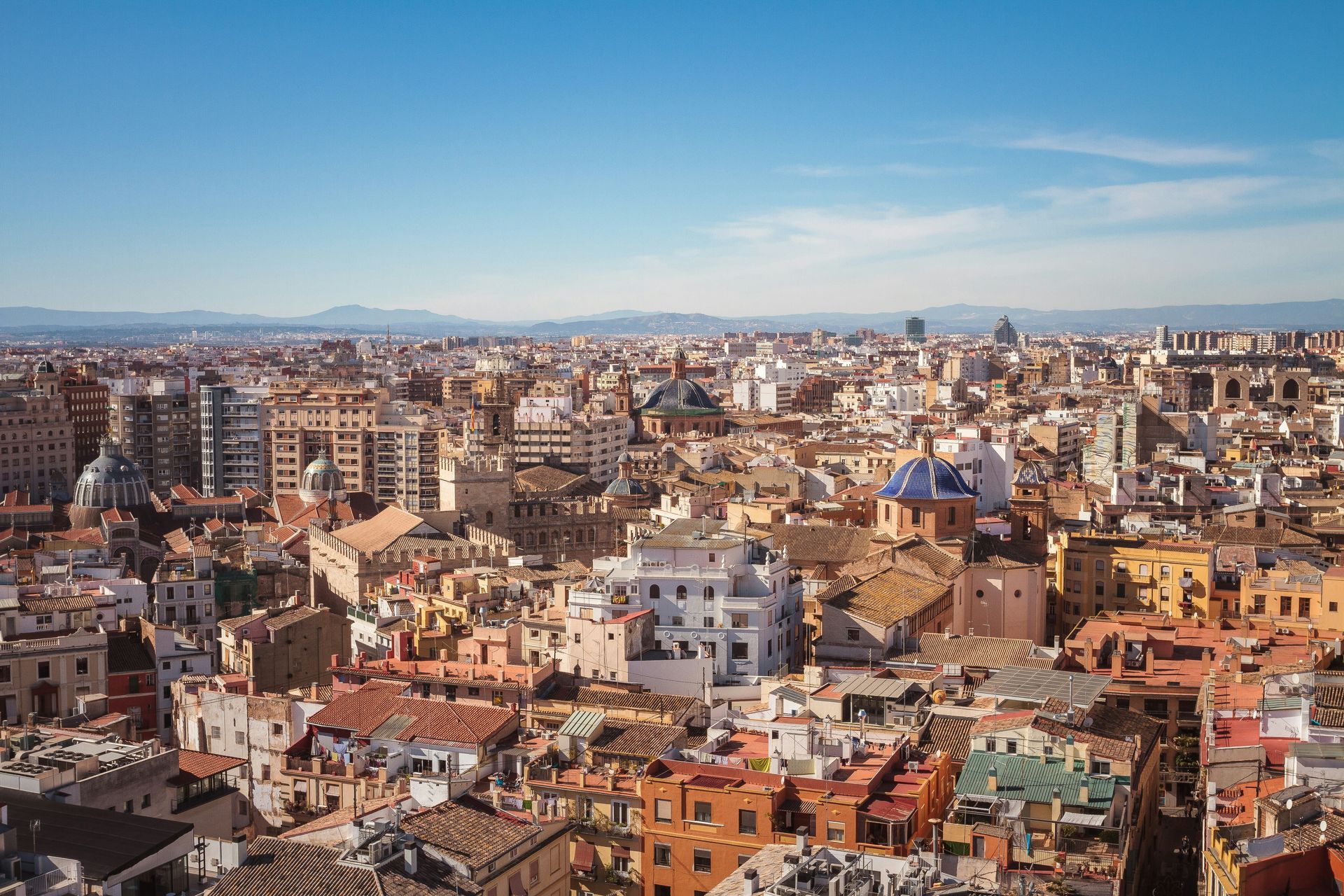 Cityscape of Valencia, Spain with colorful buildings under a clear blue sky.