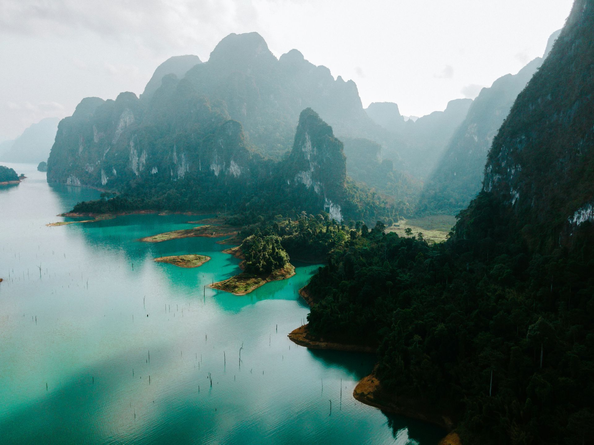 An aerial view of a lake surrounded by mountains and trees in Khao Sok National Park. Thailand.