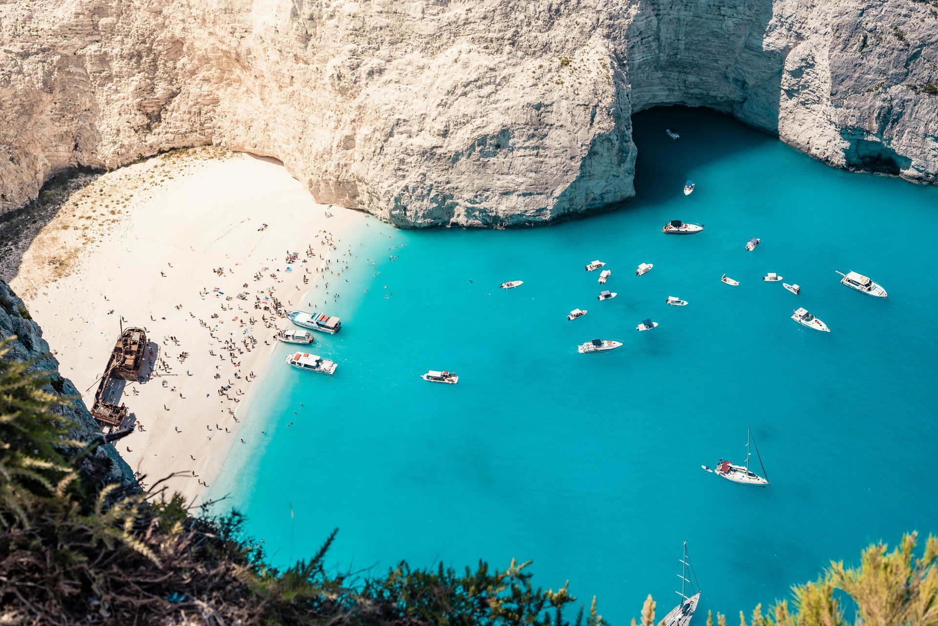 There are many boats in the water near the beach in Zakynthos, Greece.