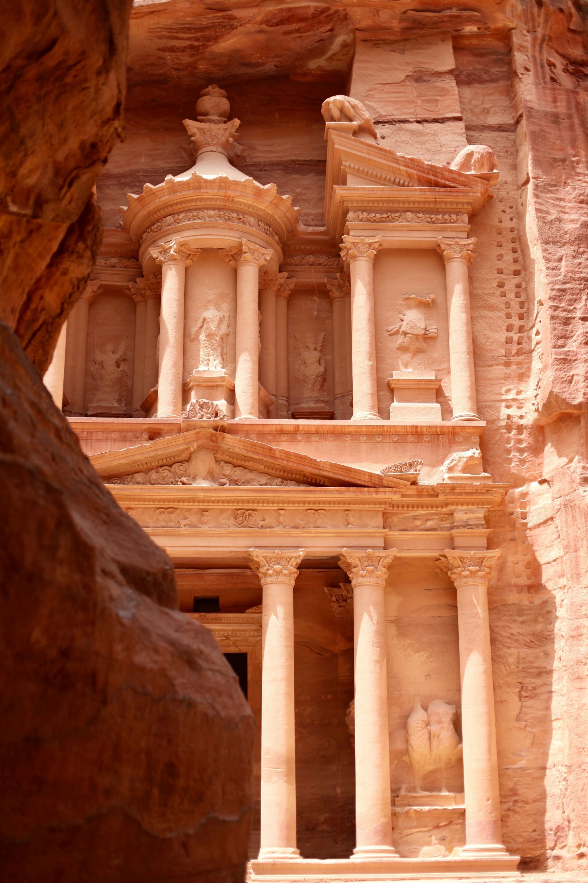 The Treasury, an ancient temple carved into sandstone cliffs in Petra, Jordan.