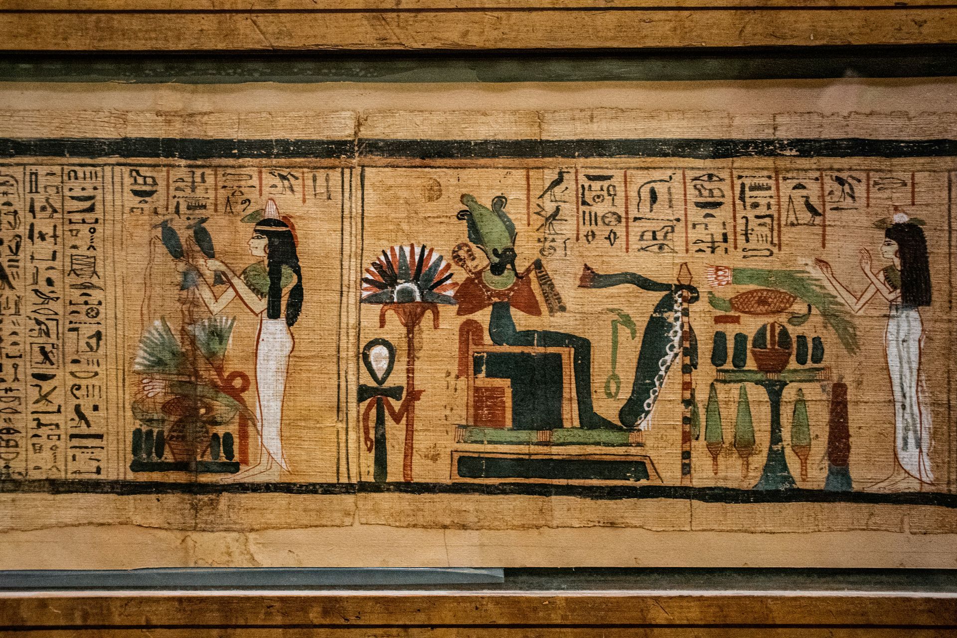 Paintings and hieroglyphs of an ancient Egyptian scene on a wall in Egypt.