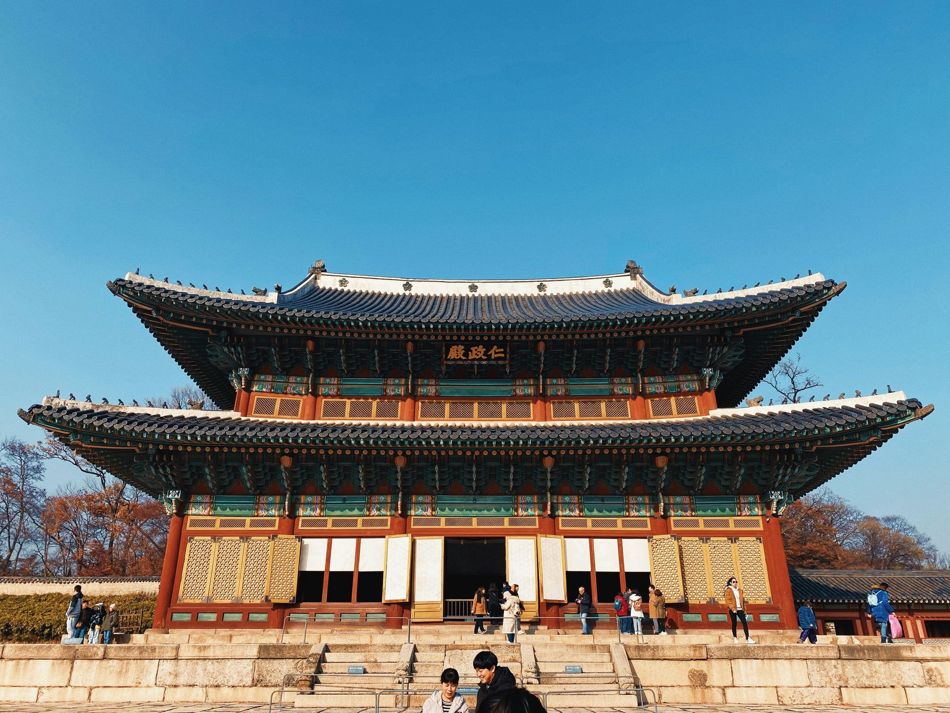 Two-tiered Changdeokgung Palace building with ornate roof and teal trim in South Korea.