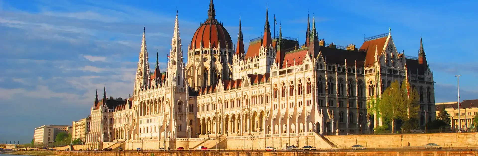 The Hungarian Parliament Building with a red dome is sitting on the Danube river in Budapest, Hungary.
