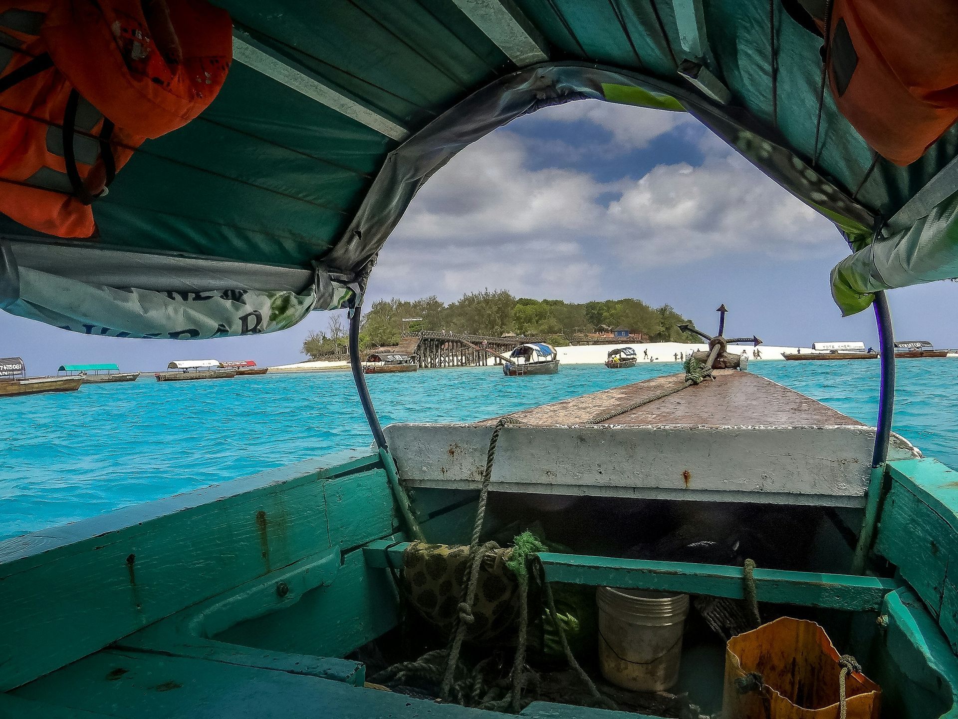 A boat is floating on top of a body of water in Zanzibar, Tanzania.