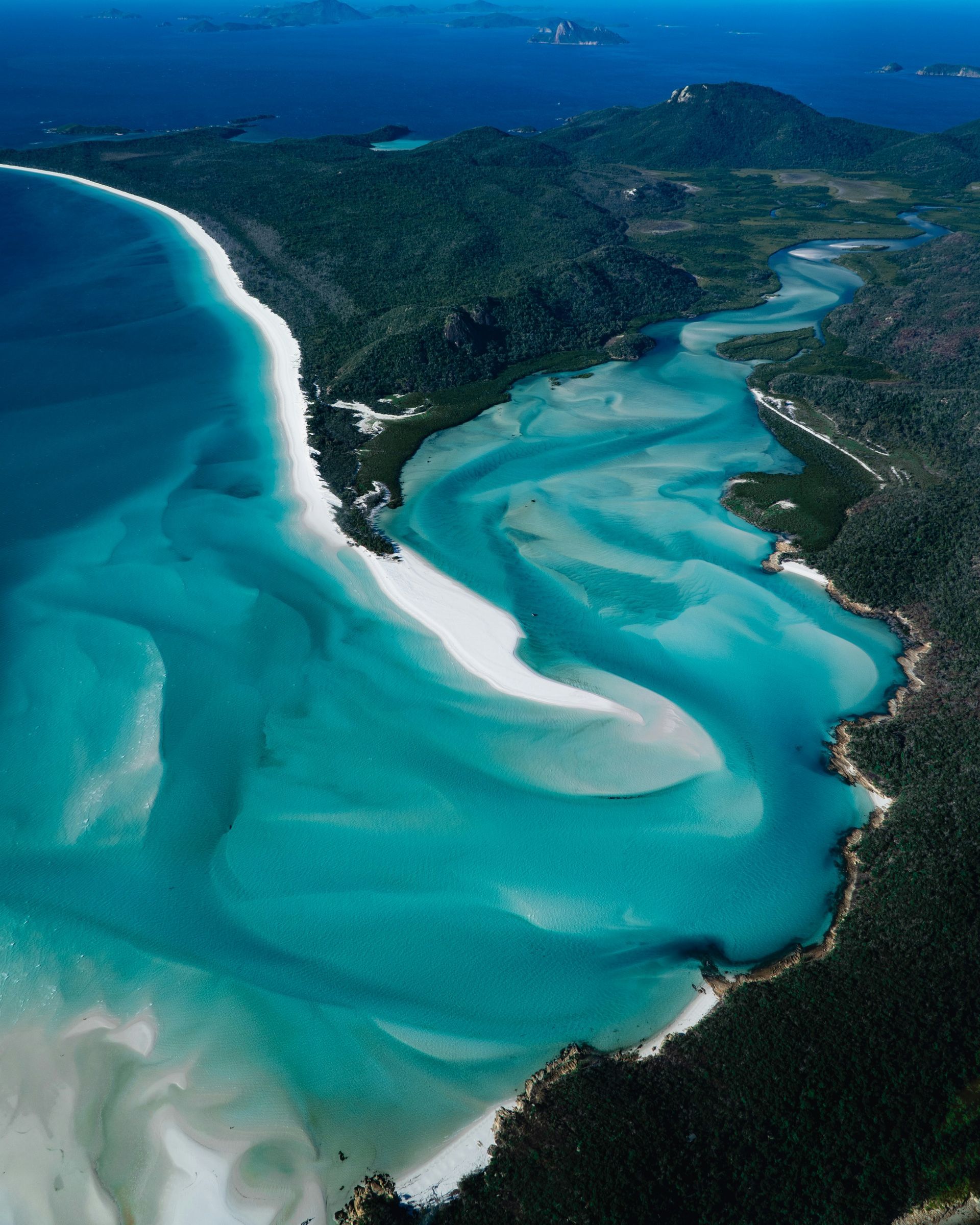 An aerial view of a beach with a river running through it in Darwin, Australia, with Silversea's Expedition cruise. 