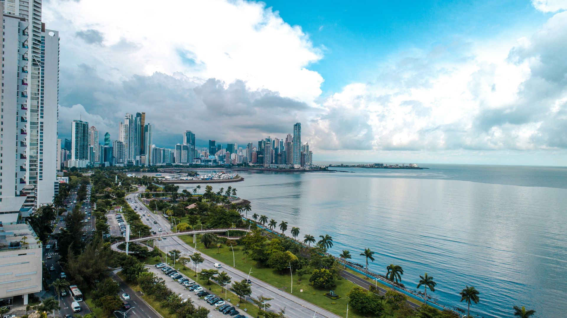 An aerial view of a city along a body of water with the Panama City, Panama skyline in the background.