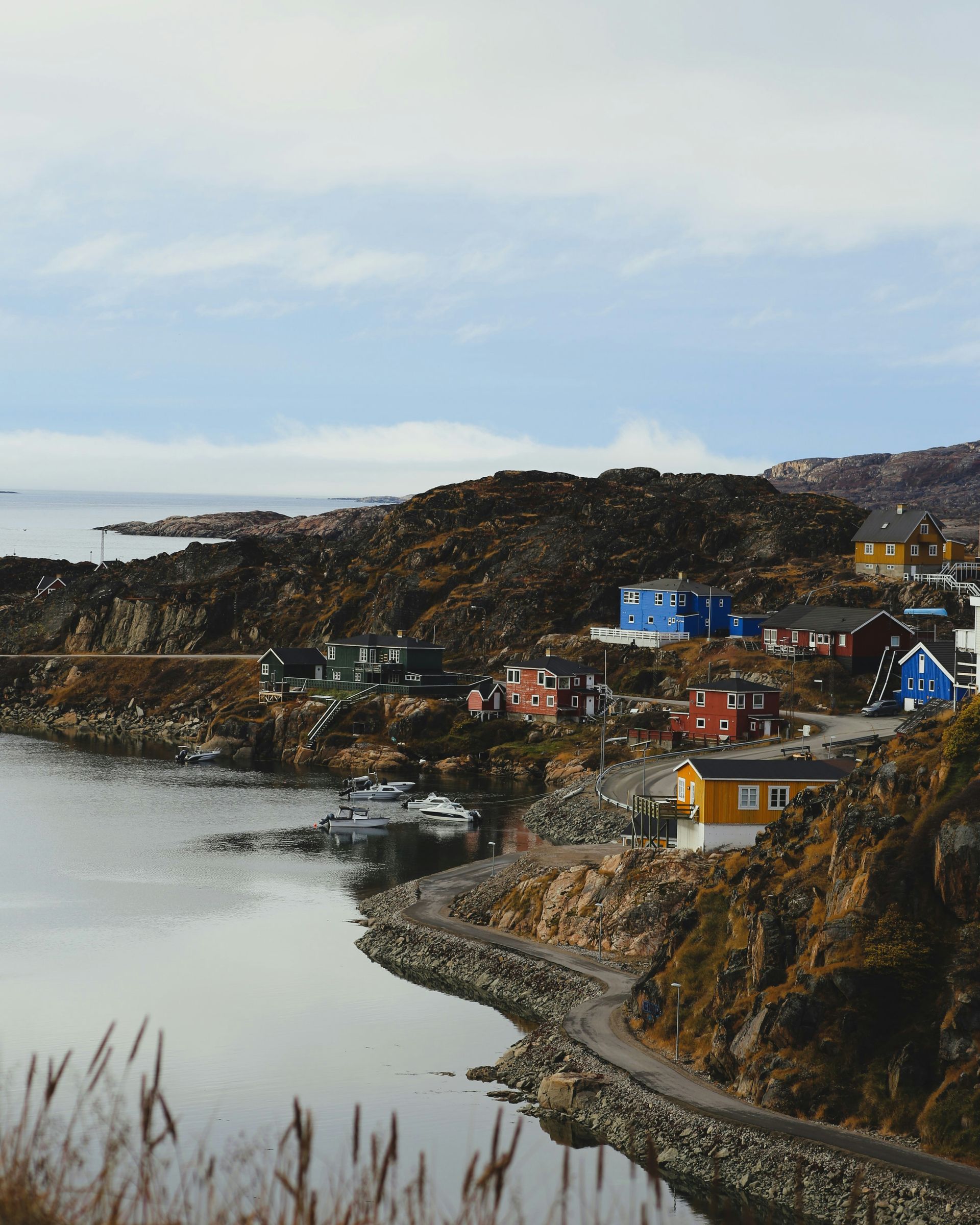 Colorful houses dot a rocky coastline in Sisimiut, Greenland.