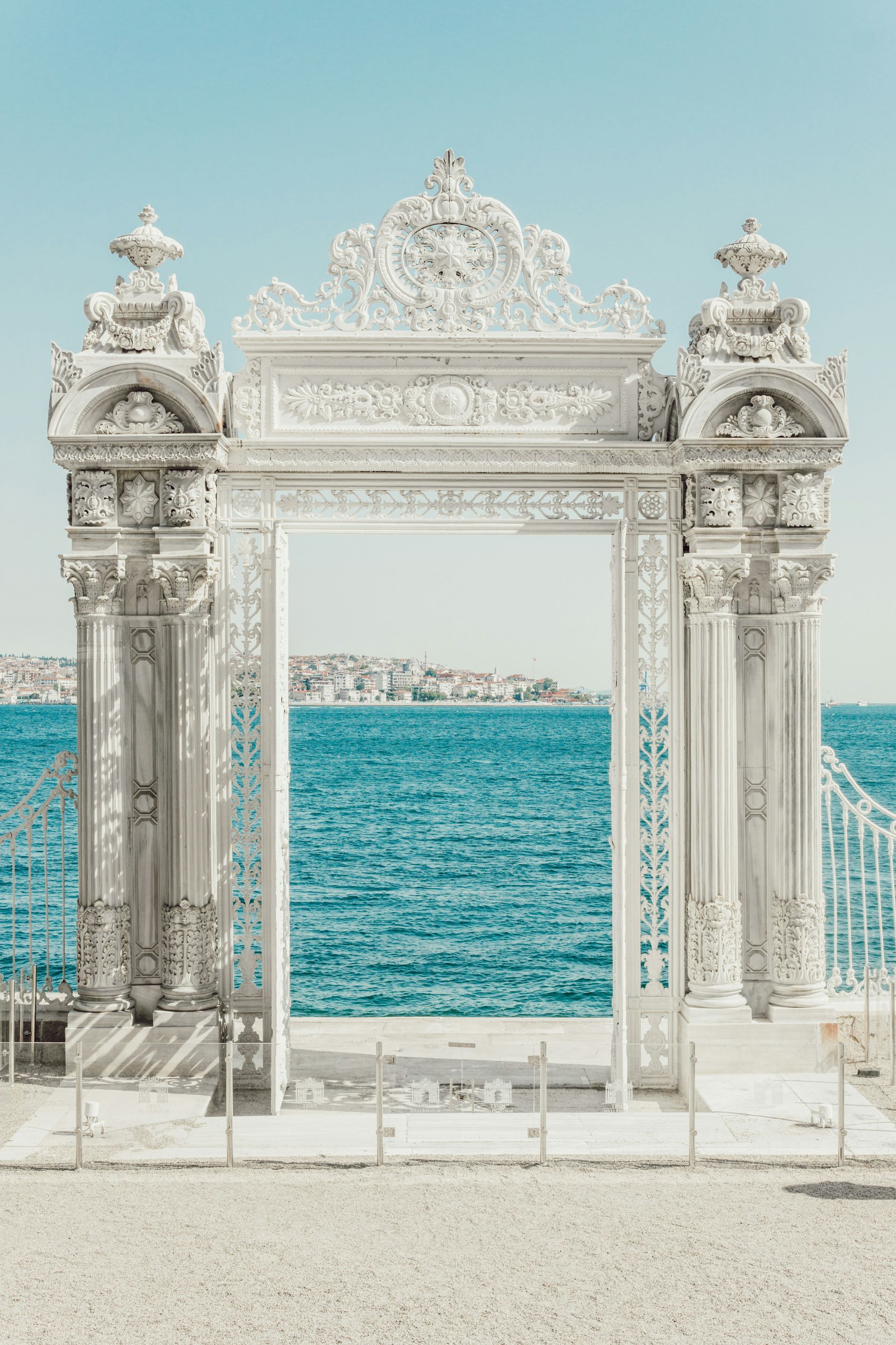 Ornate white gate overlooking turquoise water in Istanbul, Turkey.